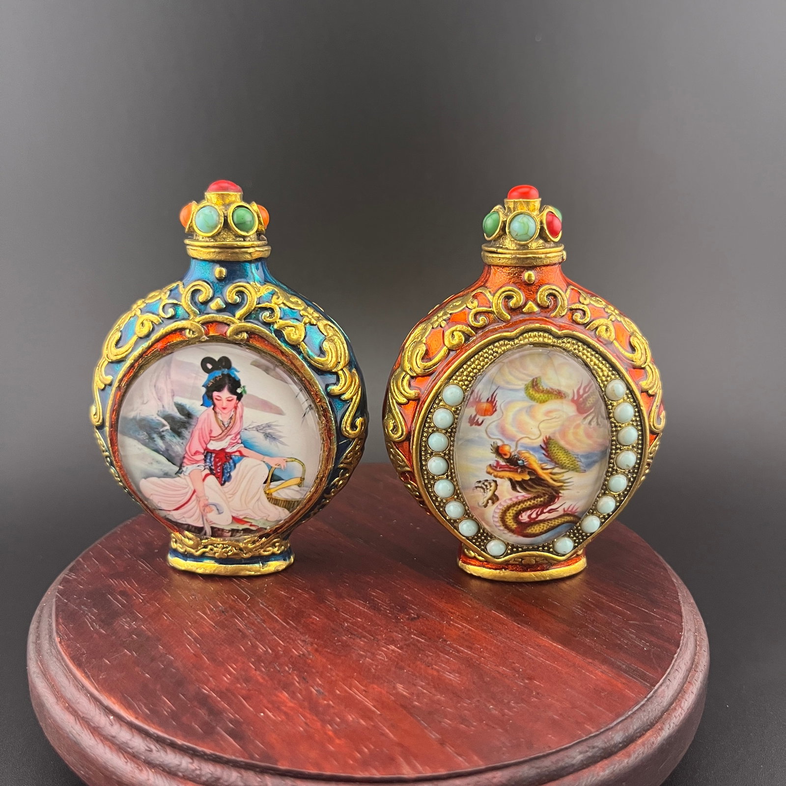 PAIR OF INSIDE-PAINTED ENAMELED SNUFF BOTTLES: Modern; Long: 2.2 inch; Width: 1.16 inch; High: 3.1 inch; Long: 2.2 inch; Width: 1.4 inch; High: 3.08 inch; . Wooden base for display only