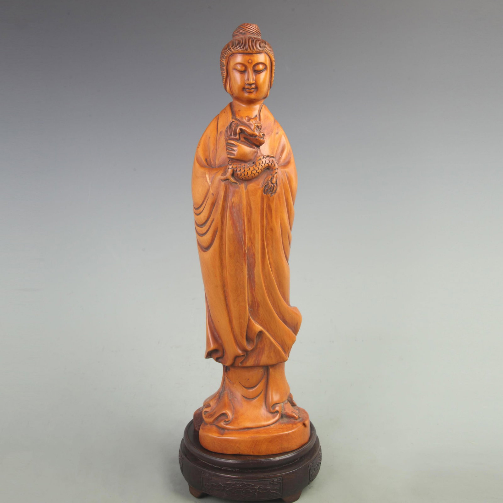 A BOXWOOD CARVED GUANYIN FIGURE: 20th Century; High: 14.8 inch; Width: 3.5 inch; Long: 4 inch; . Wooden base for display only