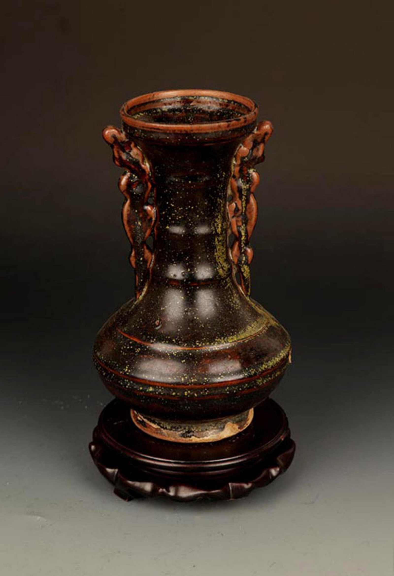 A BLACK COLOR GLAZED DOUBLE EAR LONG NECK BOTTLE: Yuan Dynasty Style; High: 8.5 inch; Diameter: 3.5 inch; . Wooden base for display only