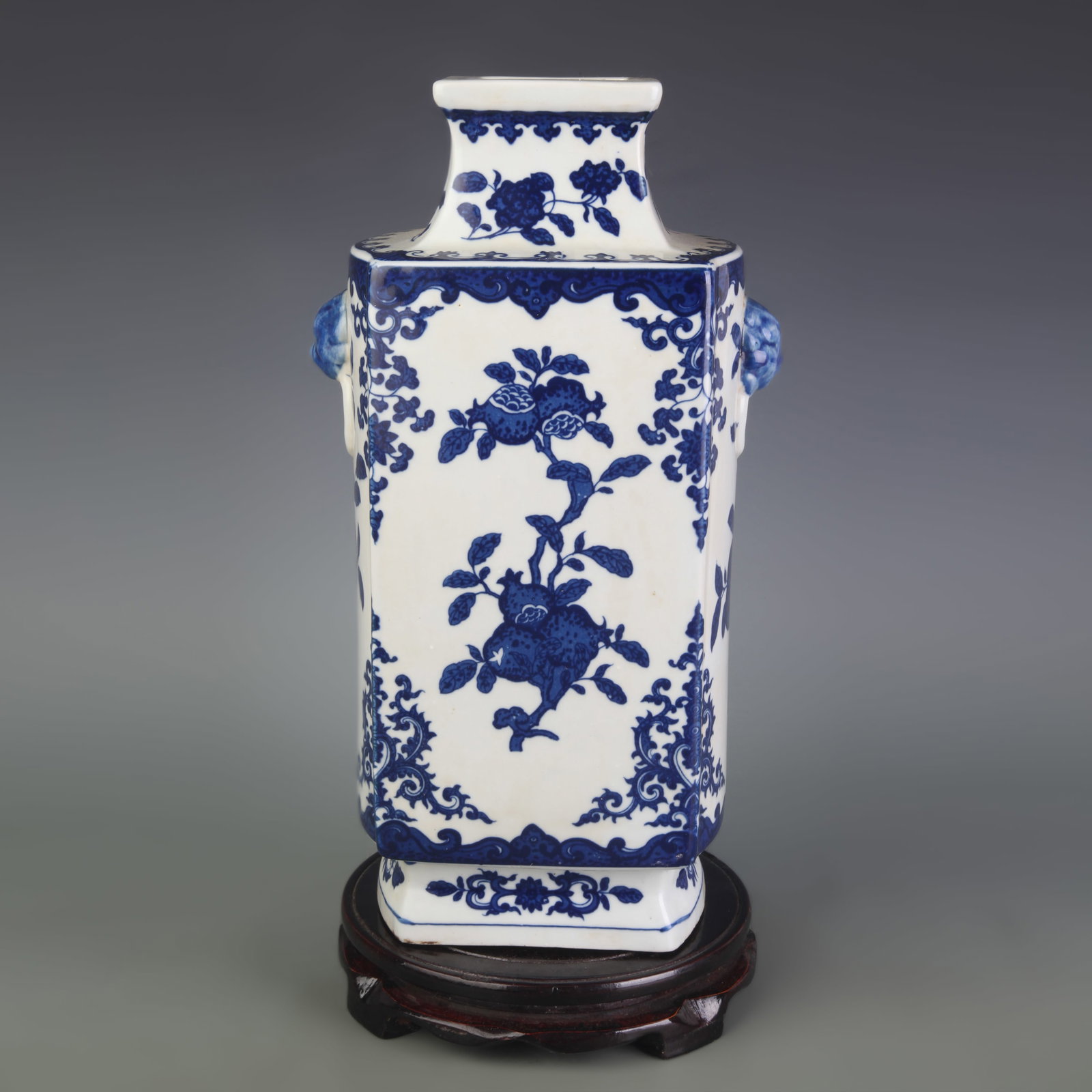 BLUE AND WHITE FLORAL DESIGN BEAST-EAR FOUR-SIDED PORCELAIN VASE: Qing Dynasty; High: 13.1 inch; Width: 3.2 inch. Wooden base for display only