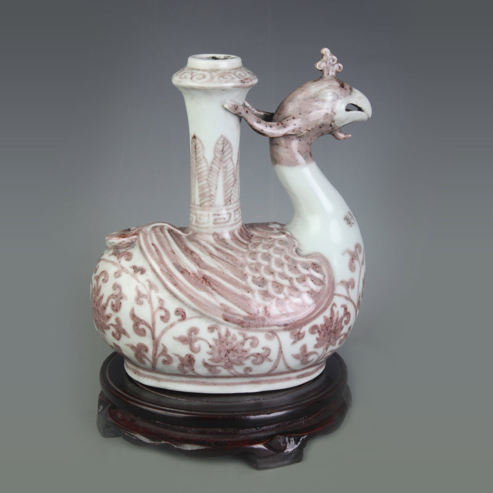 A UNDERGLAZE RED PHOENIX-HEAD PORCELAIN VASE: Ming Dynasty Xuan De Style; Width: 7.2 inch; High: 8.2 inch. Wooden base for display only