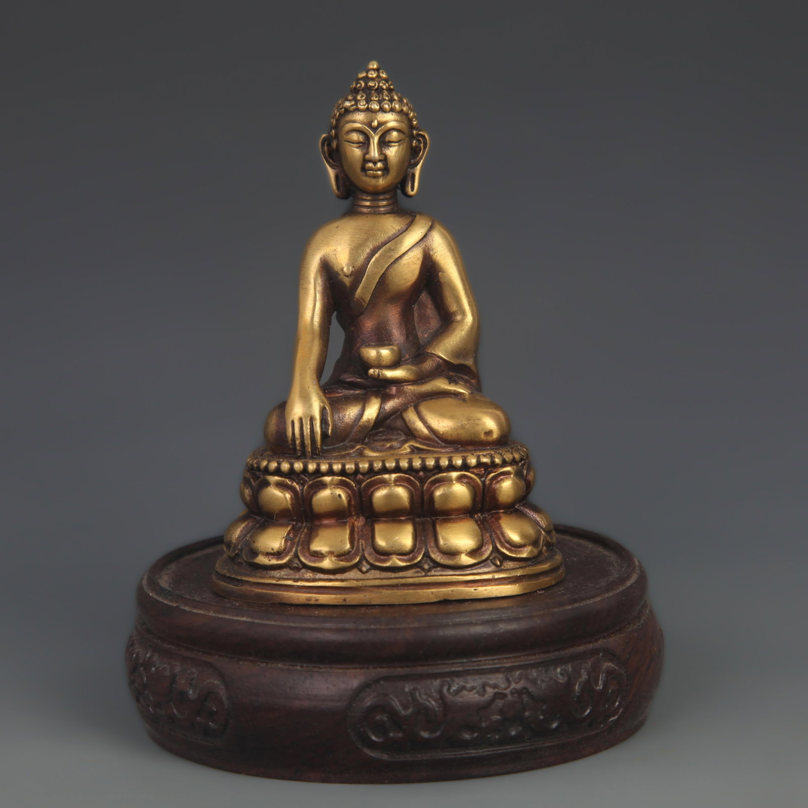 A FINE TIBETAN BRONZE SHAKYAMUNI BUDDHA: 19th Century; High: 3.50 inch; Width: 2.50 inch. Wooden base for display only