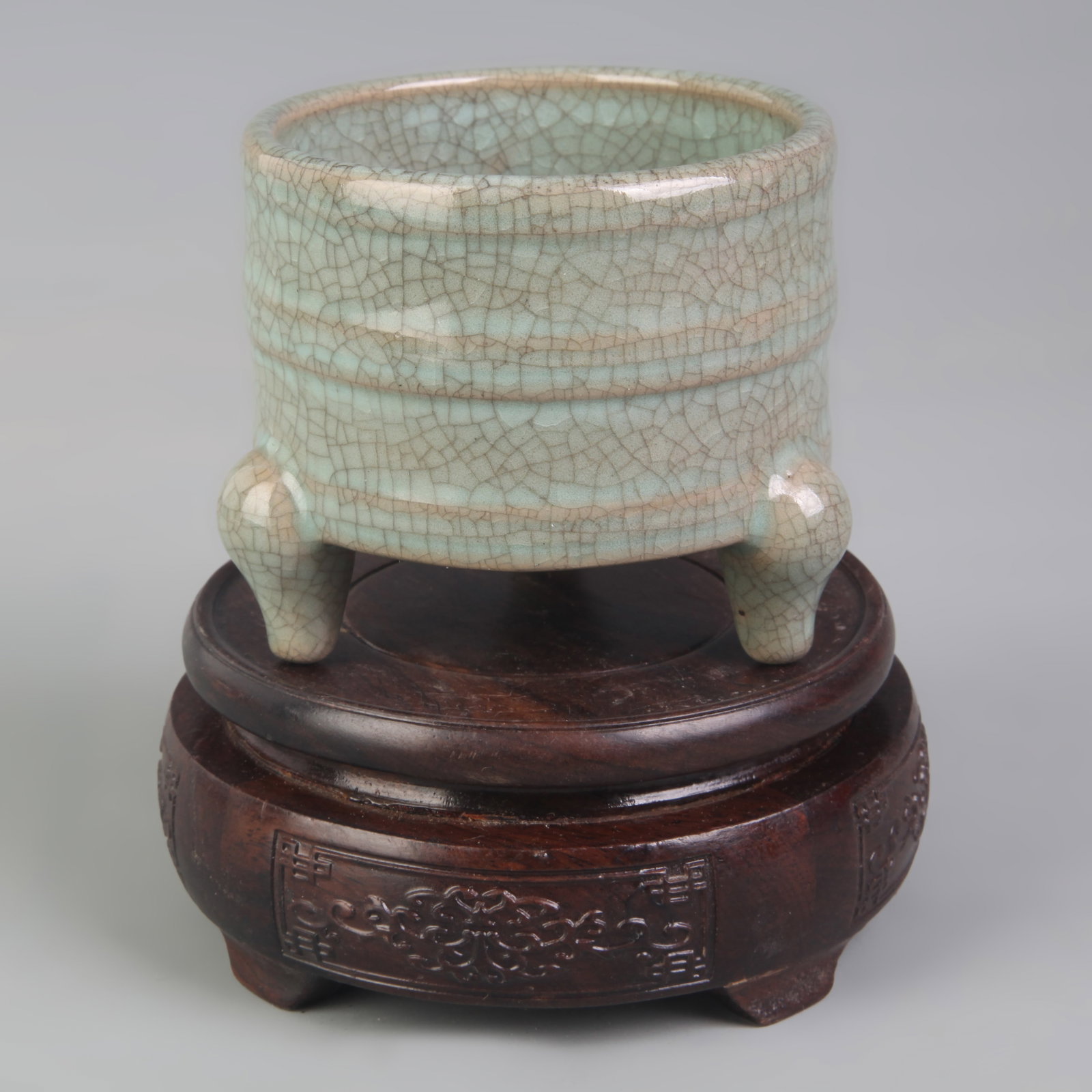 LIGHT BLUE KILN THREE-LEGGED PORCELAIN INCENSE BURNE: Qing Dynasty; High: 3.0 inch; Diameter: 3.30 inch; . Wooden base for display only