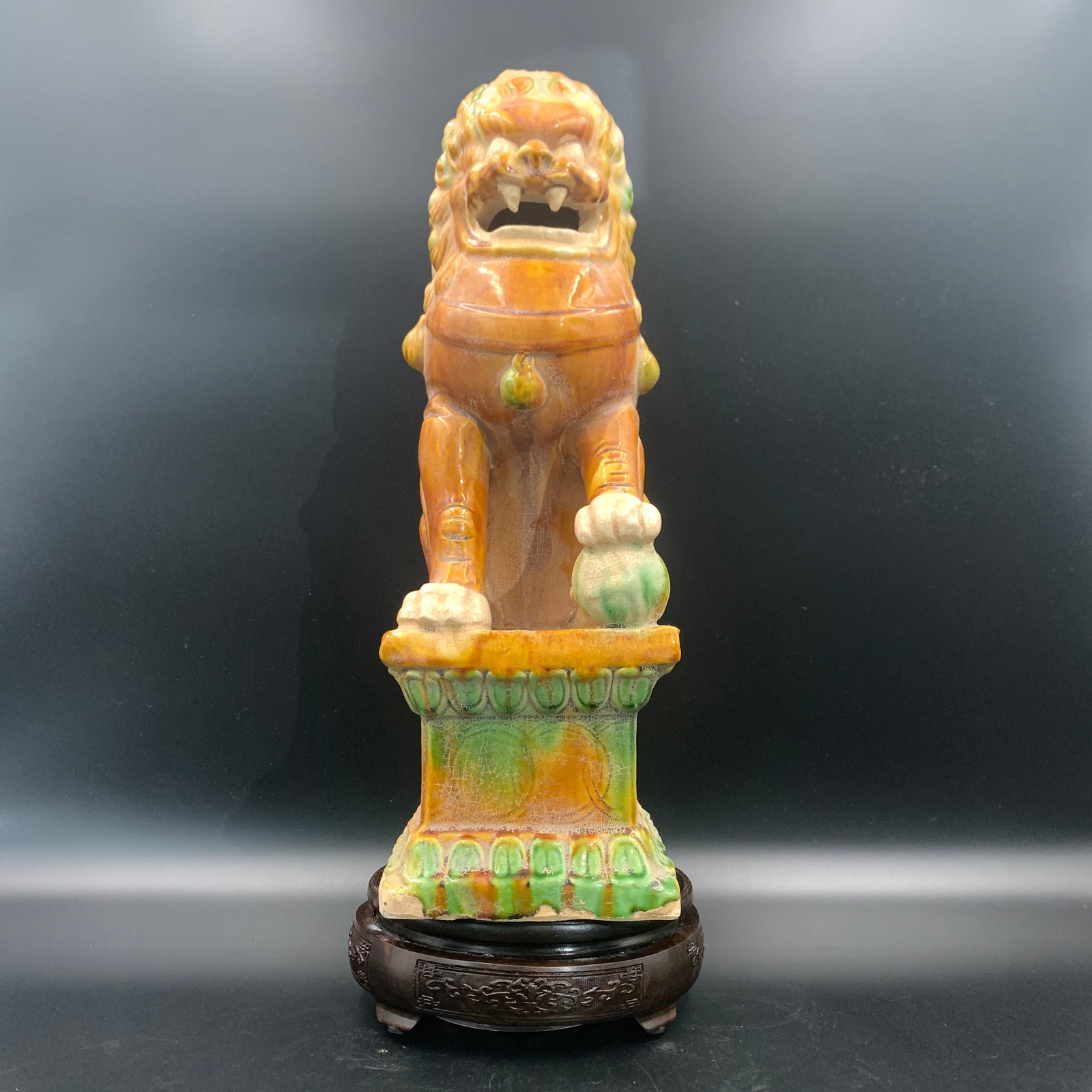 A FINE SANCAI-GLAZED BUDDHIST LION (GUARDIAN FOO DOG): Ming Dynasty Style; Long: 6.1 inch; Width: 4.5 inch; High: 15.9 inch; . Wooden base for display only