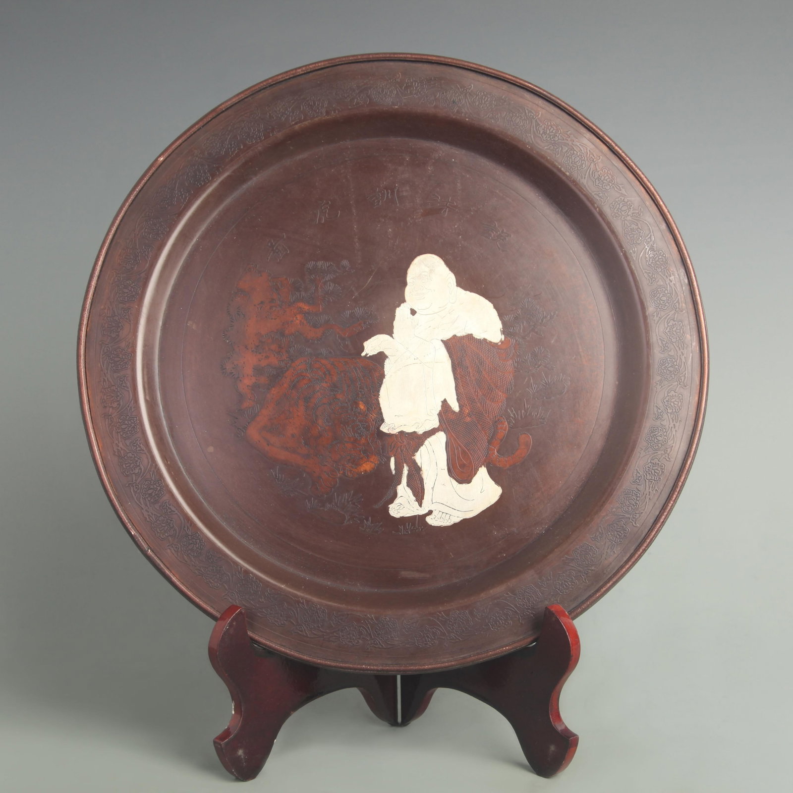 A FINE BRONZE AND SILVER INLAY CHARACTER PLATE: 19th Century; Diameter: 11.5 inch; . Wooden base for display only