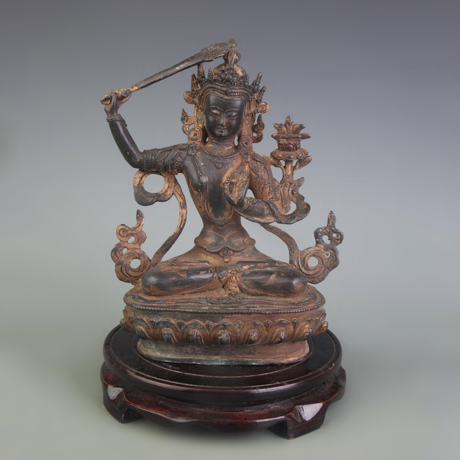 A FINE BRONZE FIGURE OF MANJUSHRI BODHISATTVA: Qing Dynasty; High: 8.1 inch; . Wooden base for display only