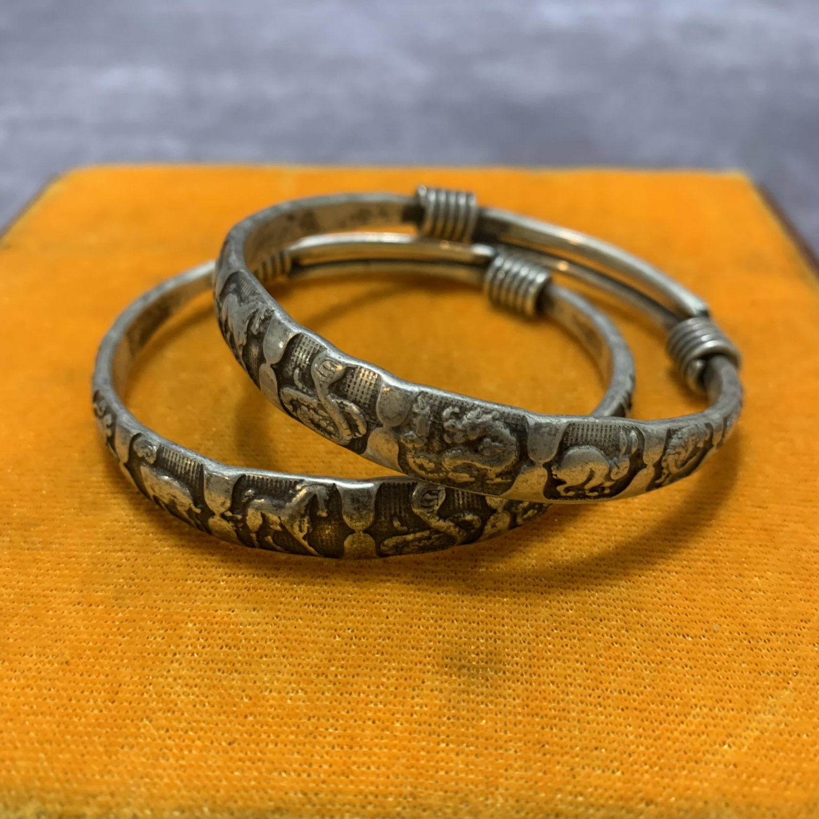 PAIR OF WHITE BRONZE BANGLE: Modern; Diameter: 2.6 inch; . Wooden base for display only