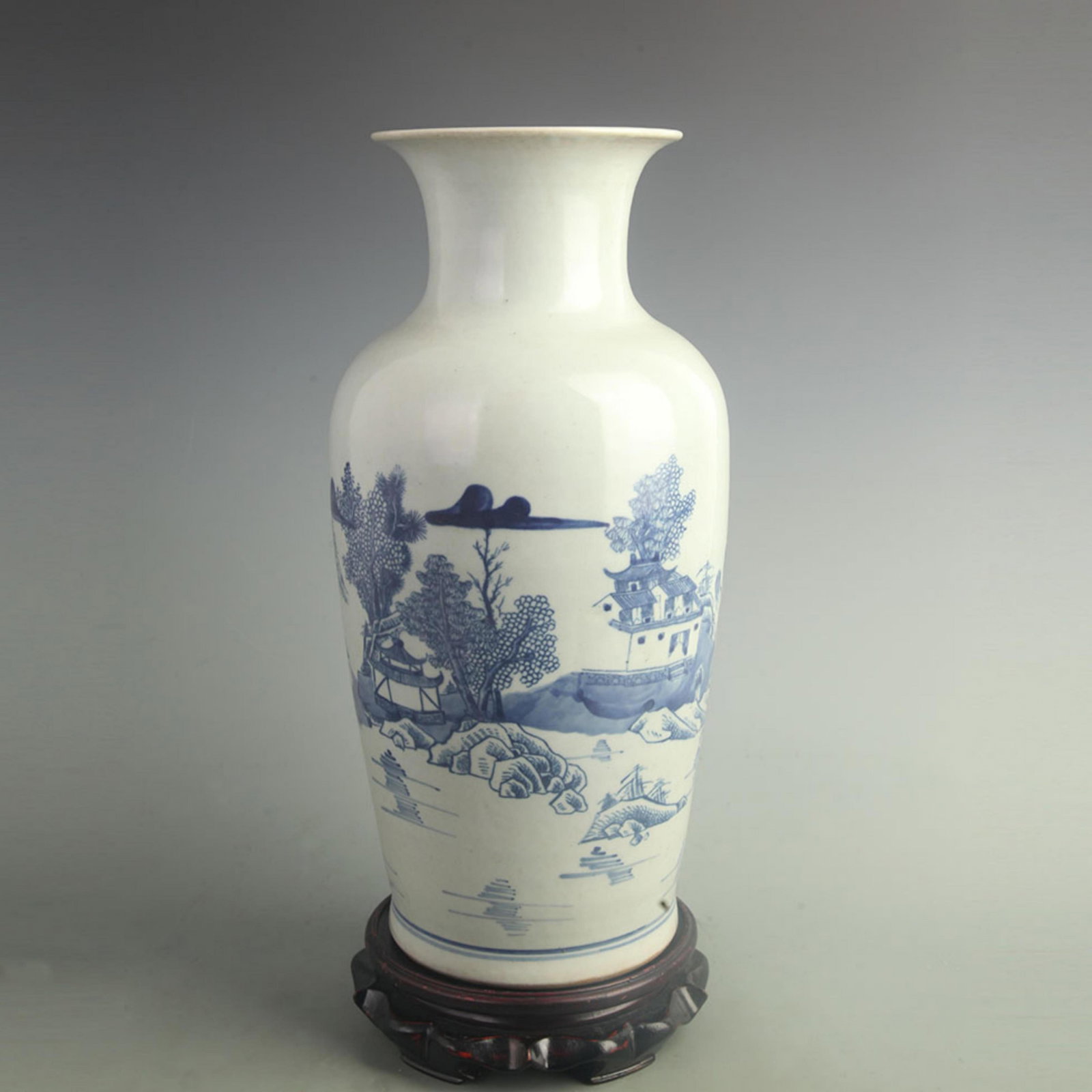 BLUE AND WHITE LANDSCAPING PATTERN VASE: Qing Dynasty; High: 15.2 inch; Width: 7.50 inch; . Wooden base for display only