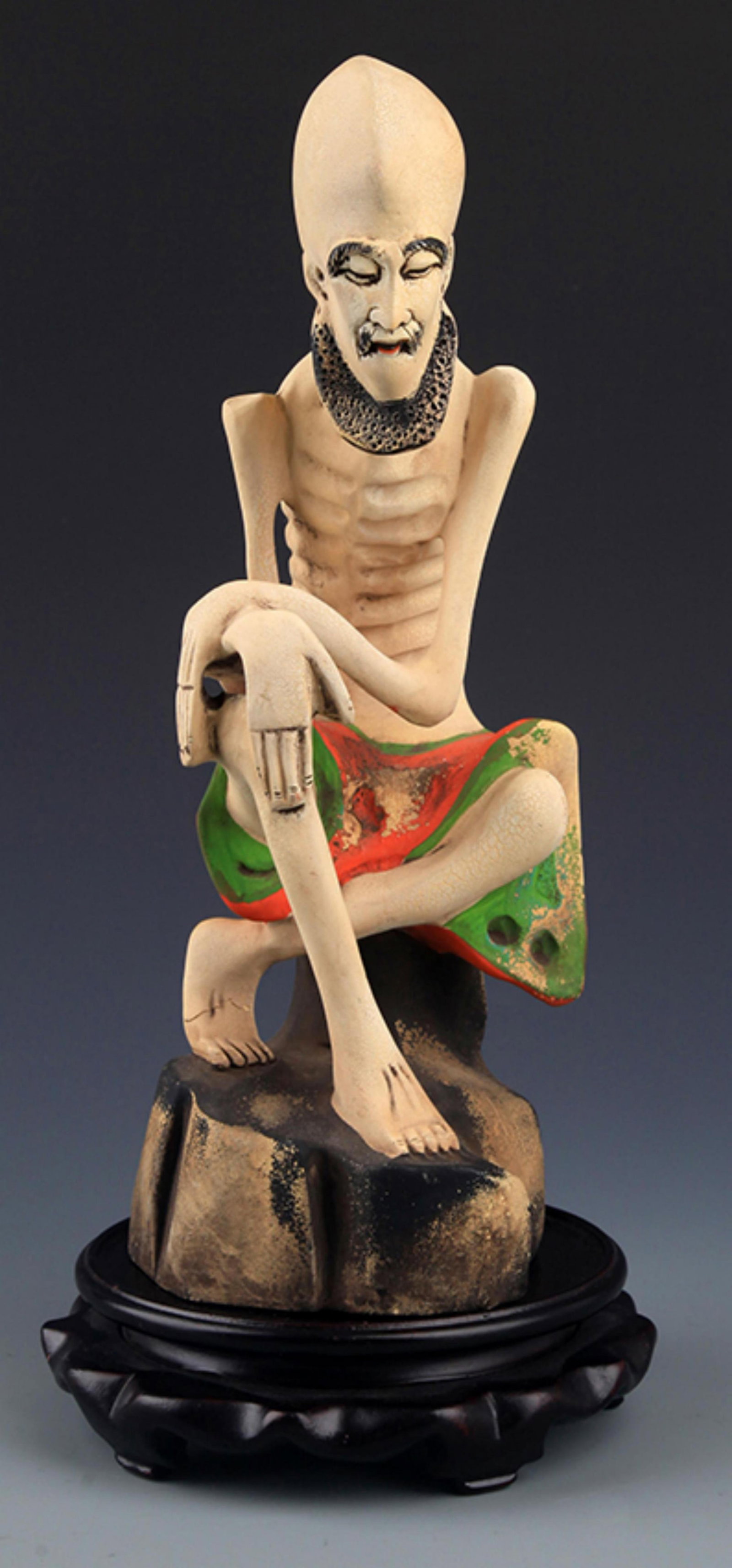 A COLORED WOODEN BODHIDHARMA FIGURE: 20th Century; High: 11.00 inch; Width: 4.0 inch; . Wooden base for display only