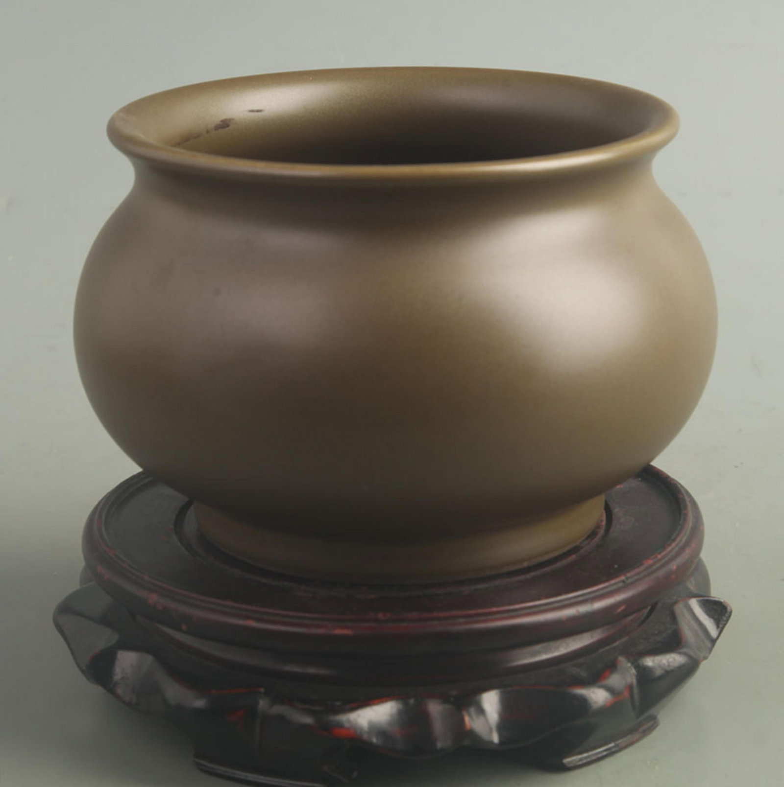 A FINE GREEN TEA COLOR GLAZED PORCELAIN INCENSE BURNER: Qing Dynasty; Yong Zheng Period; High: 4.20 inch; Diameter: 5.60 inch; . Wooden base for display only