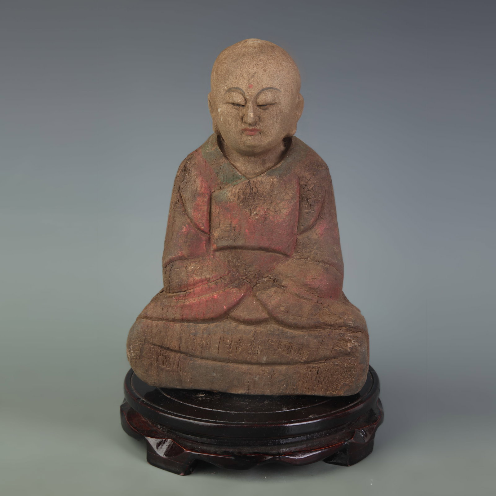 A PAINTED WOOD BUDDHA STATUE: 20th Century; High: 16.8 inch. Wooden base for display only