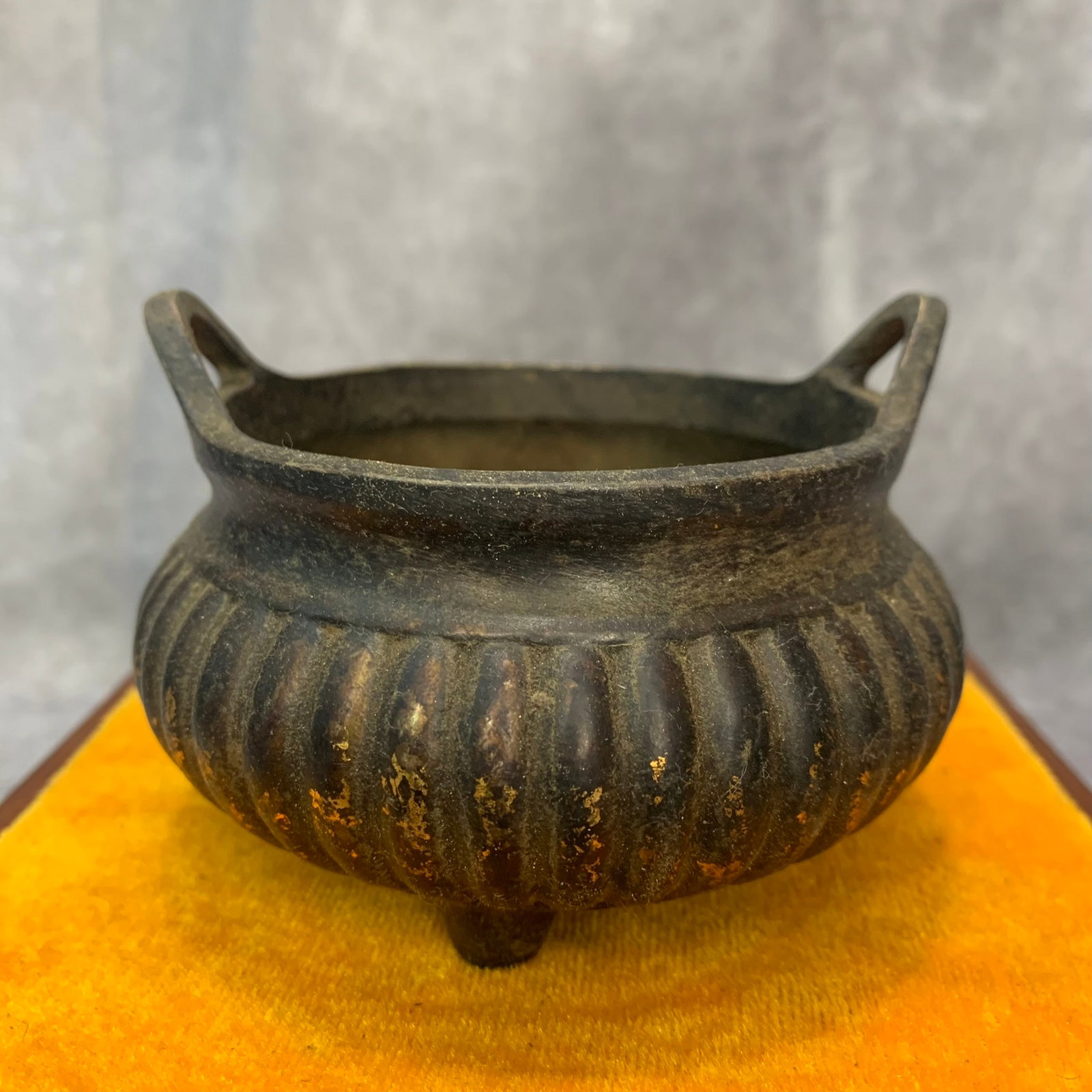 A FINE TRIPOD BRONZE INCENSE BURNER: 19th Century; High: 2.7 inch; Diameter: 3.9 inch. Wooden base for display only