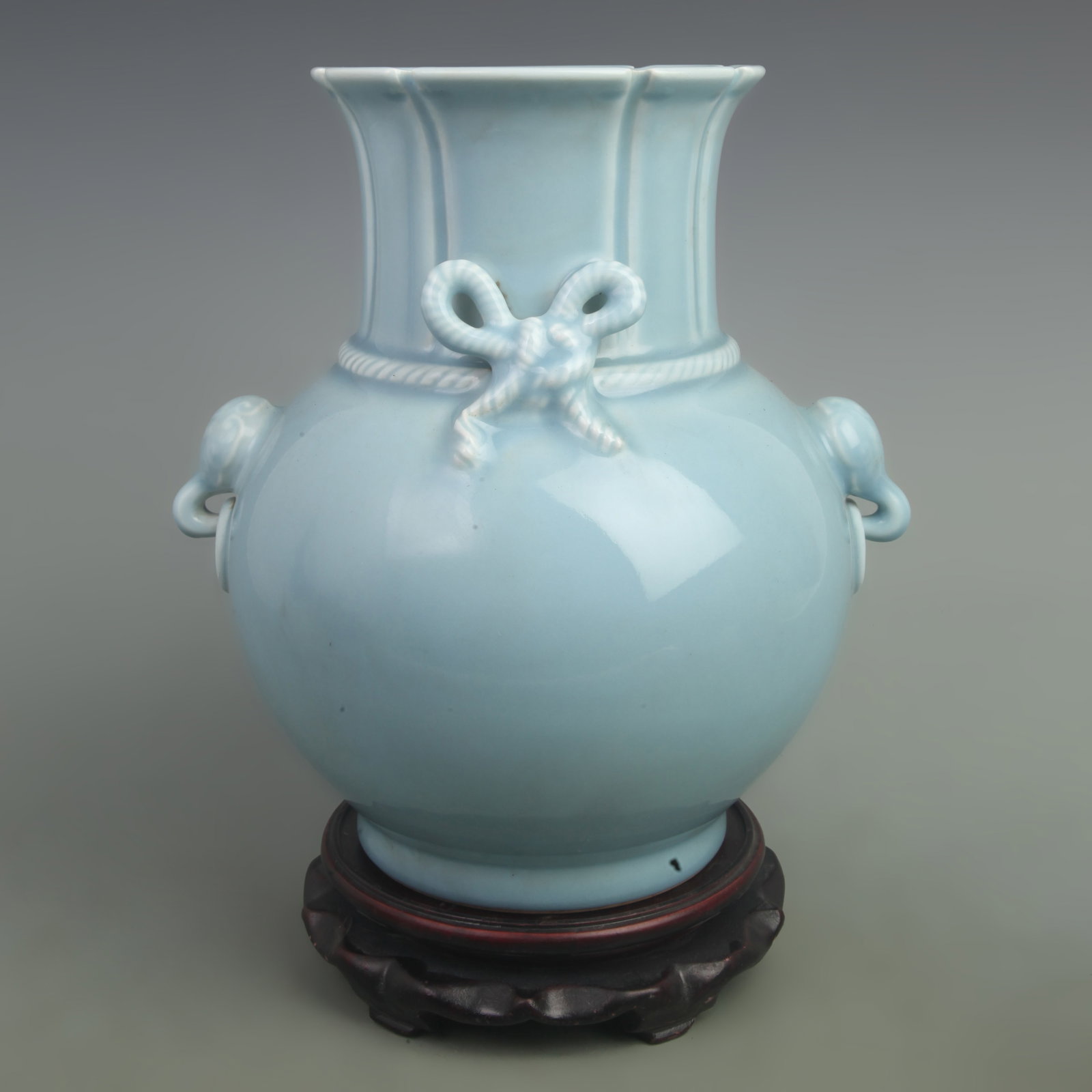 LIGHT BLUE GLAZE BUTTERFLY KNOT ELEPHANT NOSE TWIN EAR PORCELAIN ZUN: Qing Dynasty Qian Long Period; High: 10.8inch; Width: 12inch. Wooden base for display only