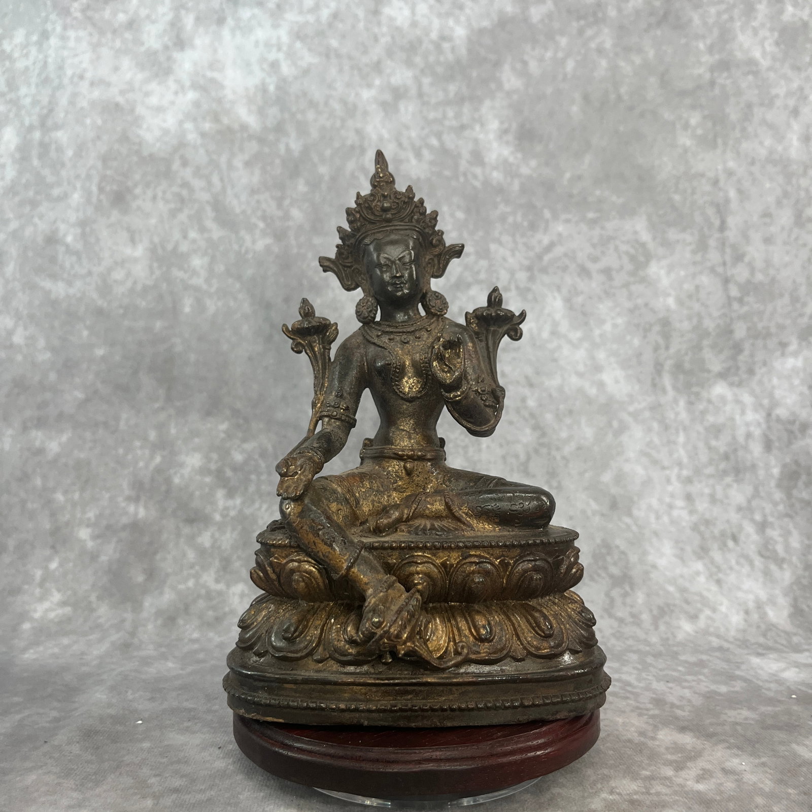 TIBETAN-STYLE PARTIAL-GILT BRONZE STATUE OF GREEN TARA: Qing Dynasty; Long: 5.4 inch; Width: 3.8 inch; High: 8.3 inch; . Wooden base for display only