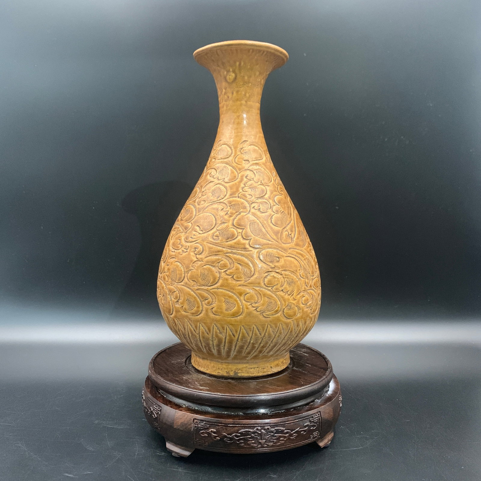 CARVED YELLOW-GLAZED CERAMIC VASE: Yuan Dynasty Style; High: 10 inch; Diameter: 5.5 inch; . Wooden base for display only