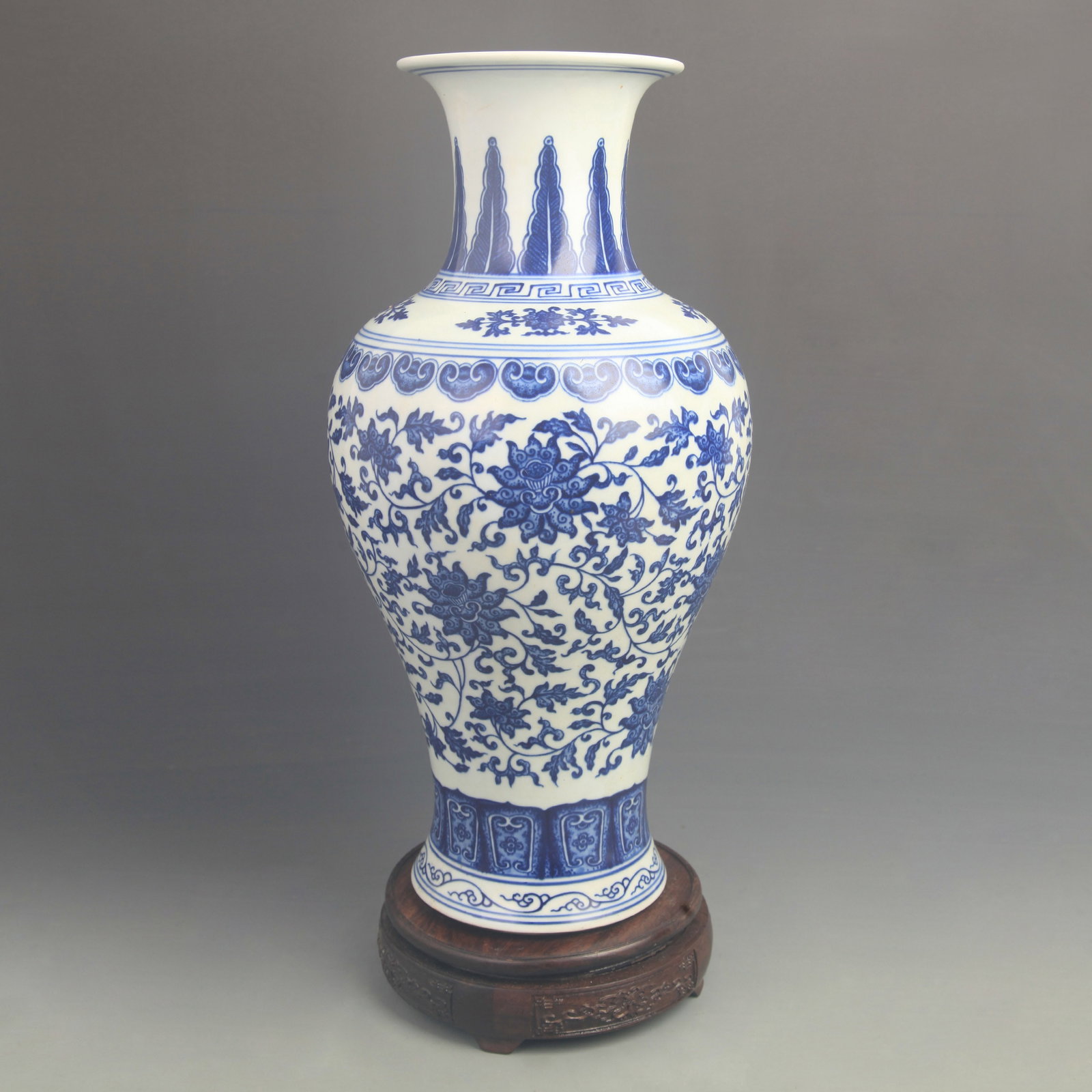 BLUE AND WHITE GUANYIN VASE WITH LOTUS TENDRIL PATTERN: Qing Dynasty Qian Long Period; High: 15.8 inch; Diameter: 7.50 inch; . Wooden base for display only