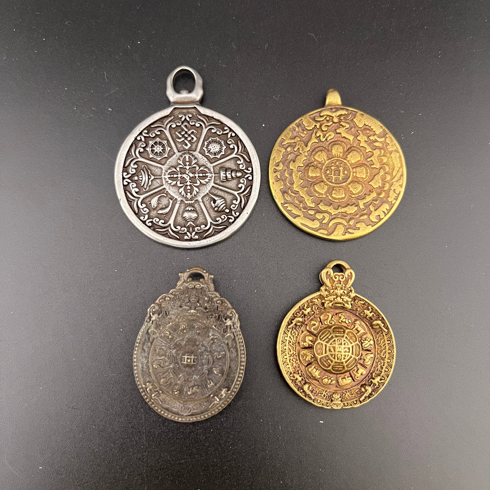 GROUP OF FOUR TIBETAN BRONZE MELONG AMULET: Qing Dynasty; Long: 2.18 inch; Width: 1.67 inch; High: 0.18 inch; Long: 1.8 inch; Width: 1.6 inch; High: 0.12 inch; Long: 1.6 inch; Width: 1.3 inch; High: 0.18 inch; Long: 1.64 inch; Width: 1.2 inch; 