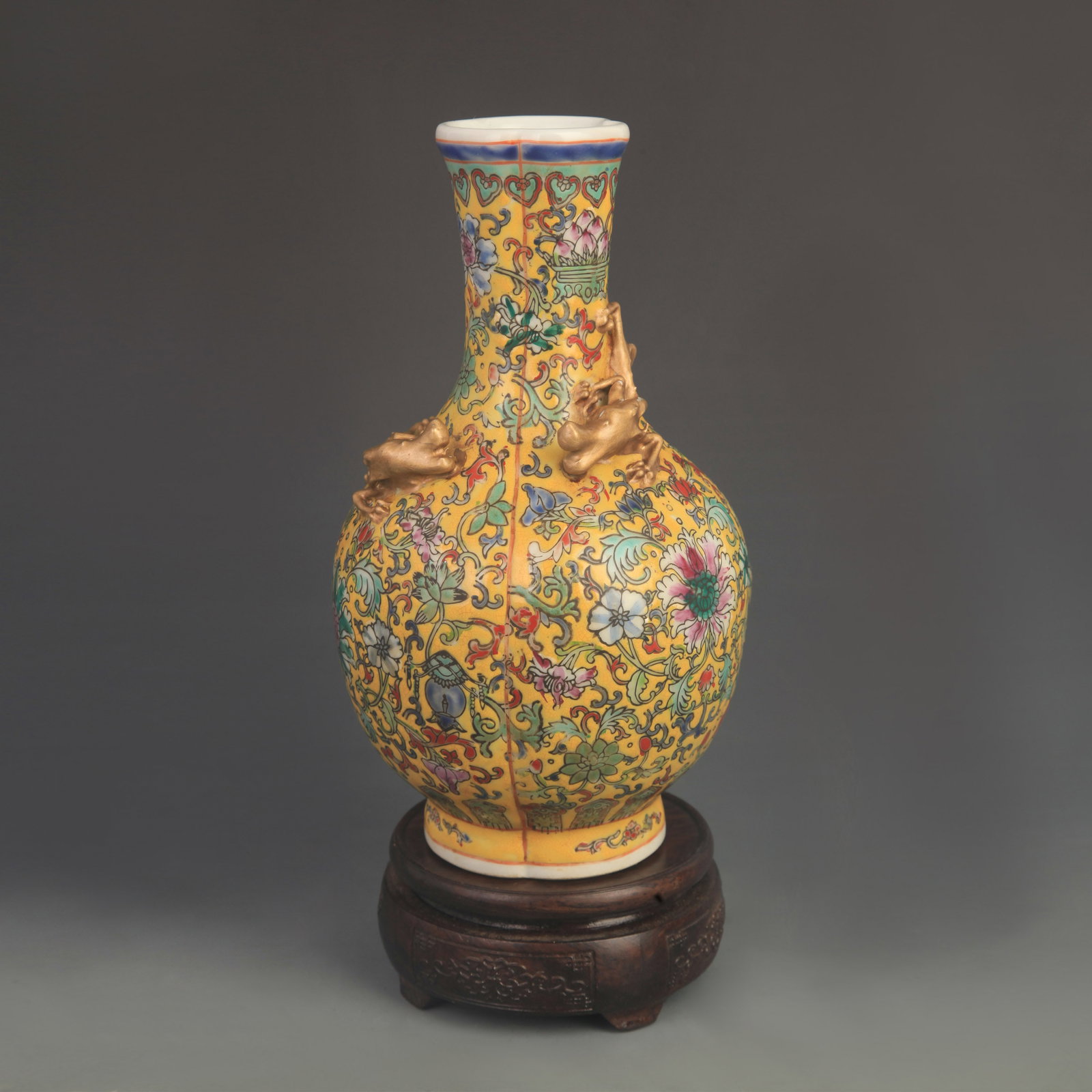 YELLOW GROUND FAMILLE ROSE CARVED DRAGON PATTERN GOURD-SHAPED VASE: Qing Dynasty; Diameter: 4.6 inch; High: 13.0 inch; . Wooden base for display only