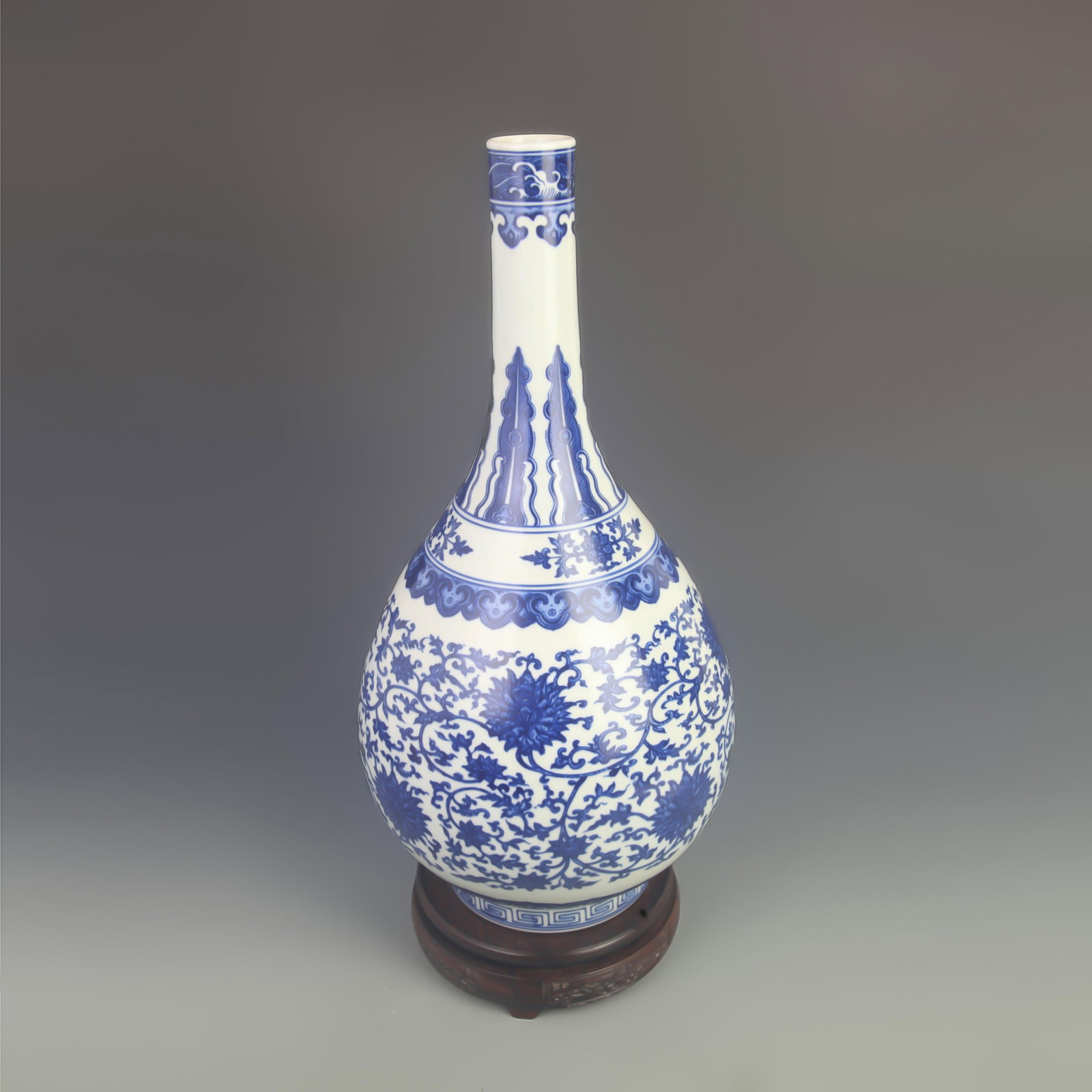 BLUE-AND-WHITE ENTWINED LOTUS LONG-NECK PATTERN PORCELAIN VASE: Qing Dynasty Qian Long Period; High: 17.0 inch; Diameter: 8.00 inch; . Wooden base for display only