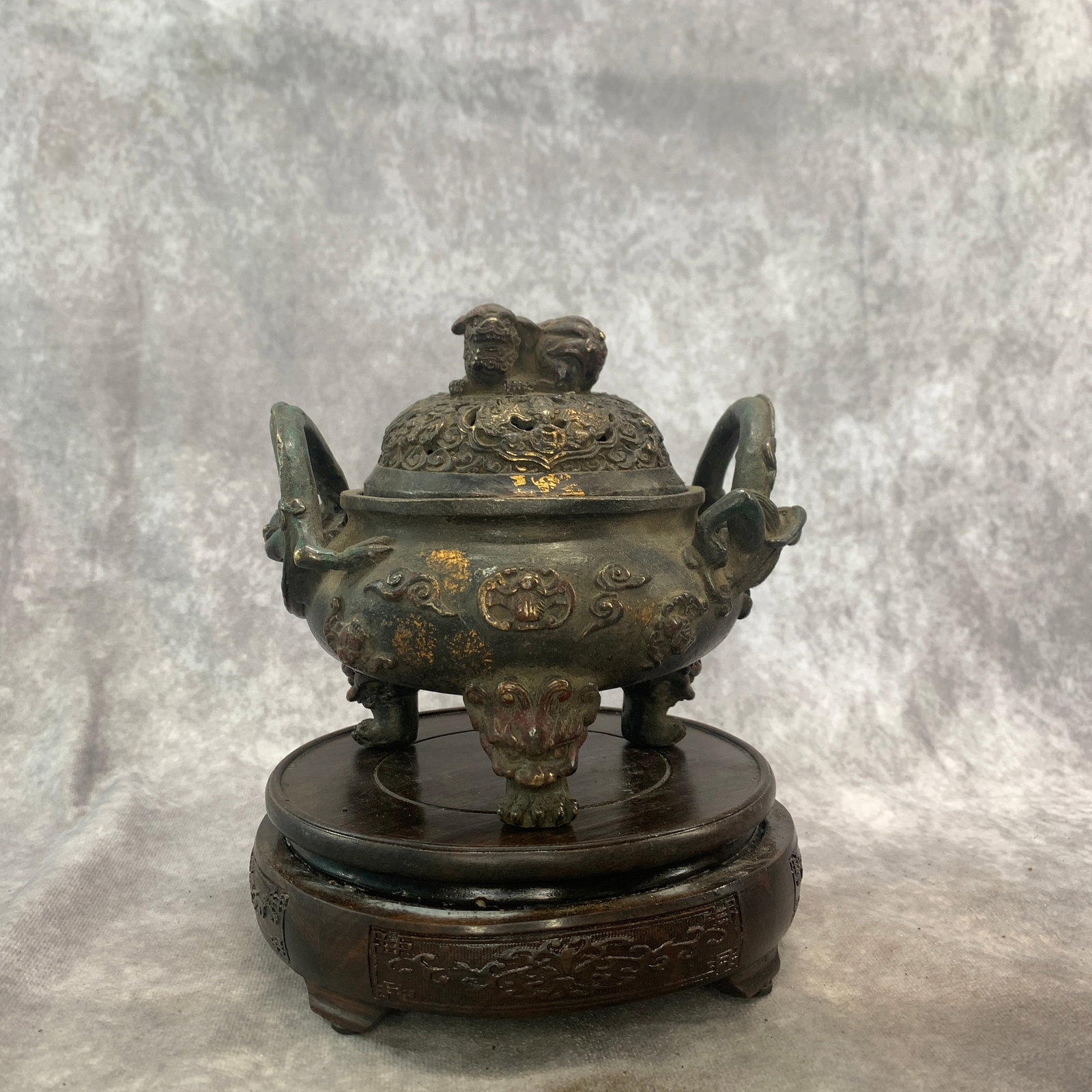 GILT-SPOTTED TRIPOD CENSER WITH FOO DOG FINIAL: Qing Dynasty; Long: 6.4 inch; Width: 5.4 inch; High: 5.9 inch; . Wooden base for display only