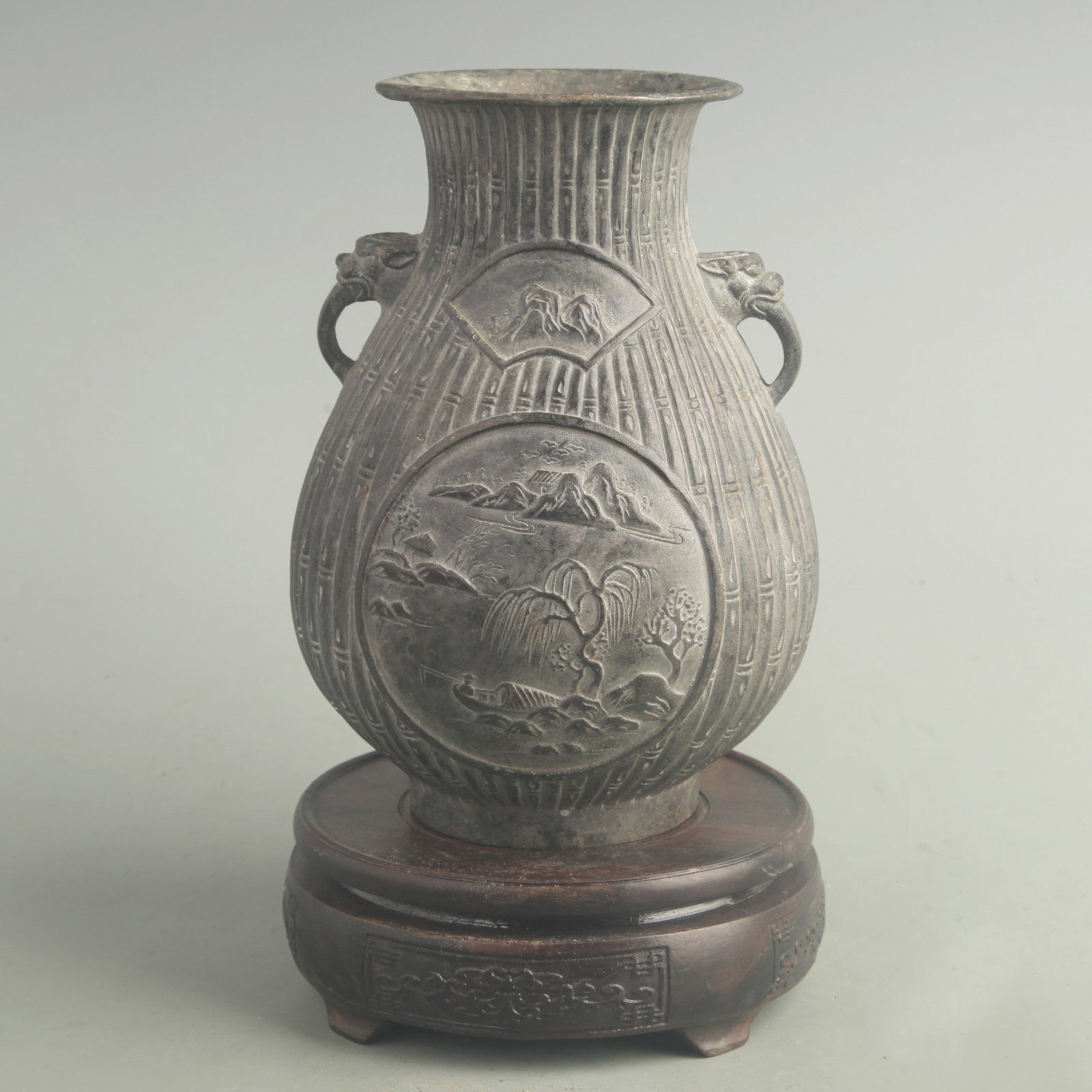 BRONZE RESERVE-PANEL VASE WITH LION HANDLES AND FLARED MOUTH: Qing Dynasty; High: 7.20 inch; Long: 5.20 inch. Wooden base for display only
