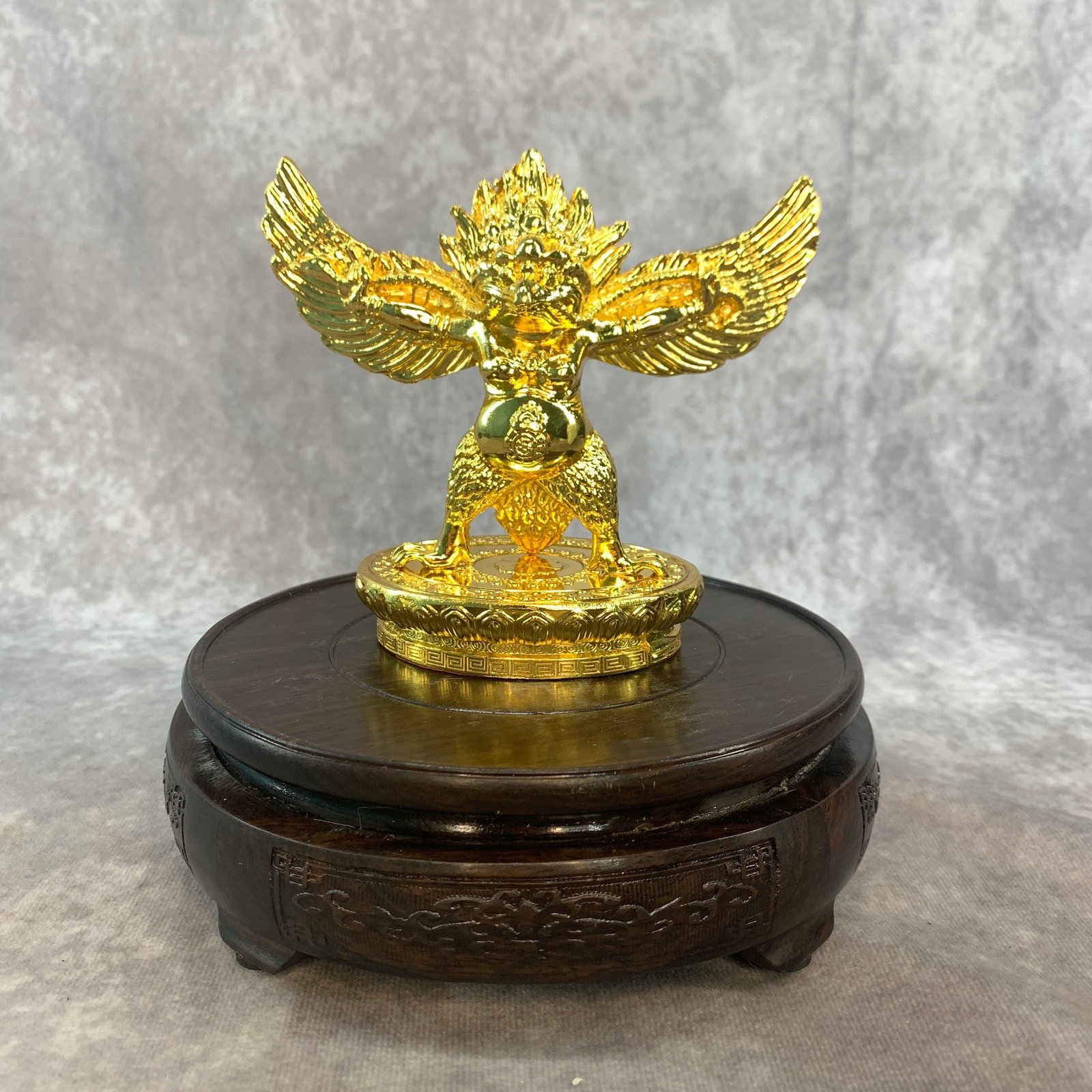A SMALL GARUDA FIGURINE: Modern; Long: 5 inch; Width: 2.6 inch; High: 4.3 inch; ;Wooden base for picture and display only.
