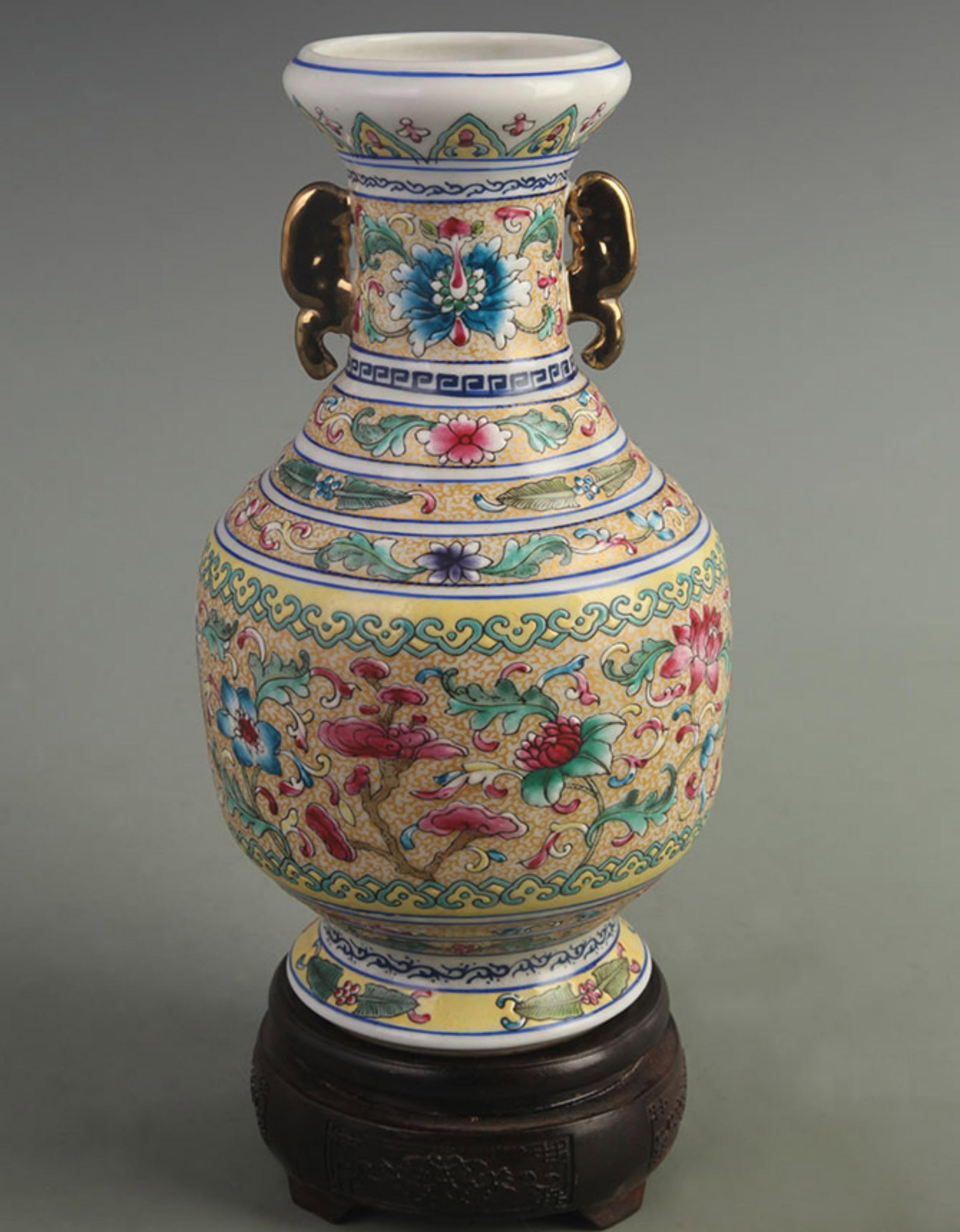 FAMILLE ROSE DOUBLE-EARED VASE WITH FLORAL DESIGN: Qing Dynasty Qian Long Period; High: 9.50 inch; Width: 5.00 inch ;Wooden base for picture and display only.