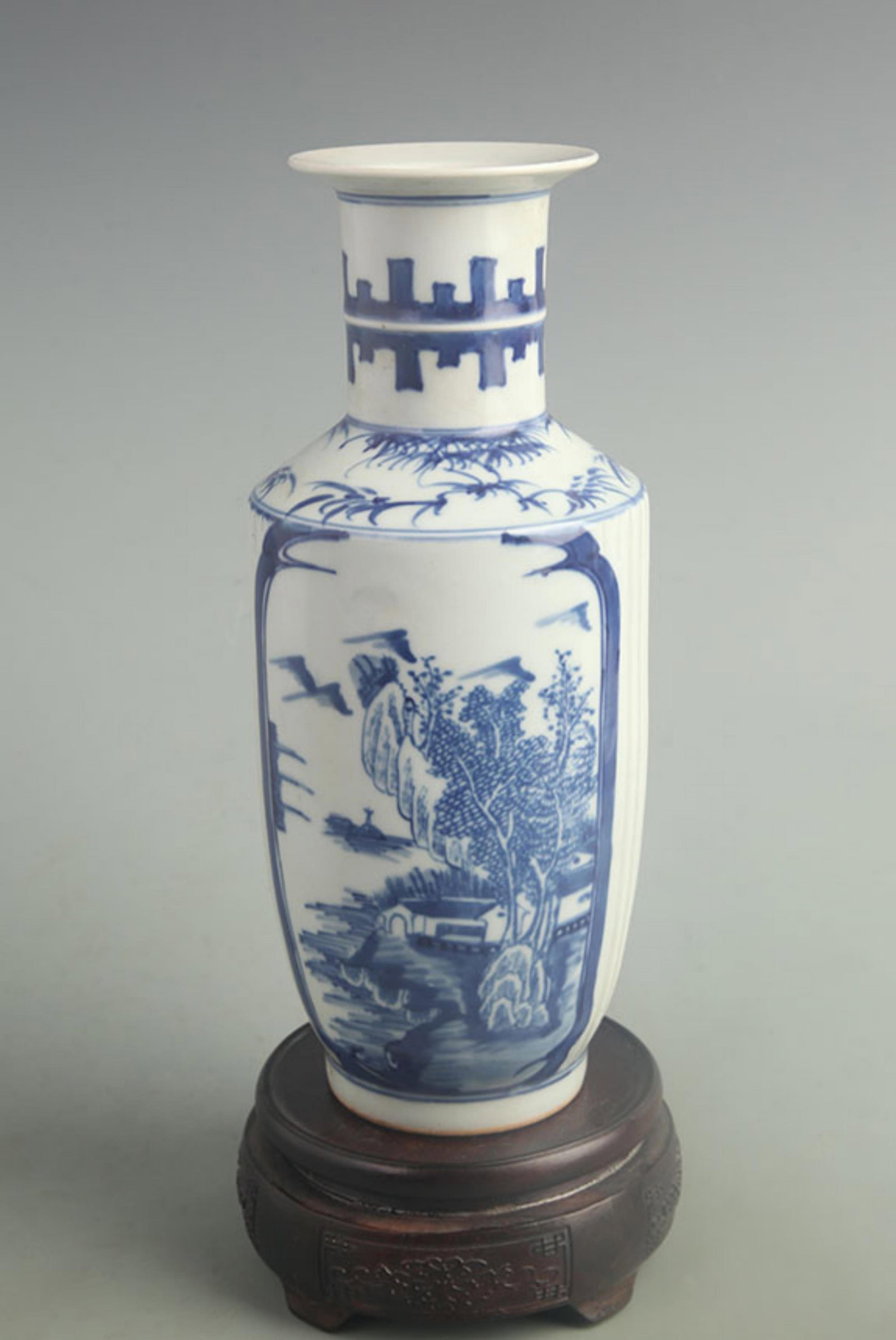 BLUE AND WHITE LANDSCAPE PATTERN PORCELAIN BOTTLE: Qing Dynasty Kang Xi Period; High: 9.50 inch; Width: 4.00 inch; ;Wooden base for picture and display only.