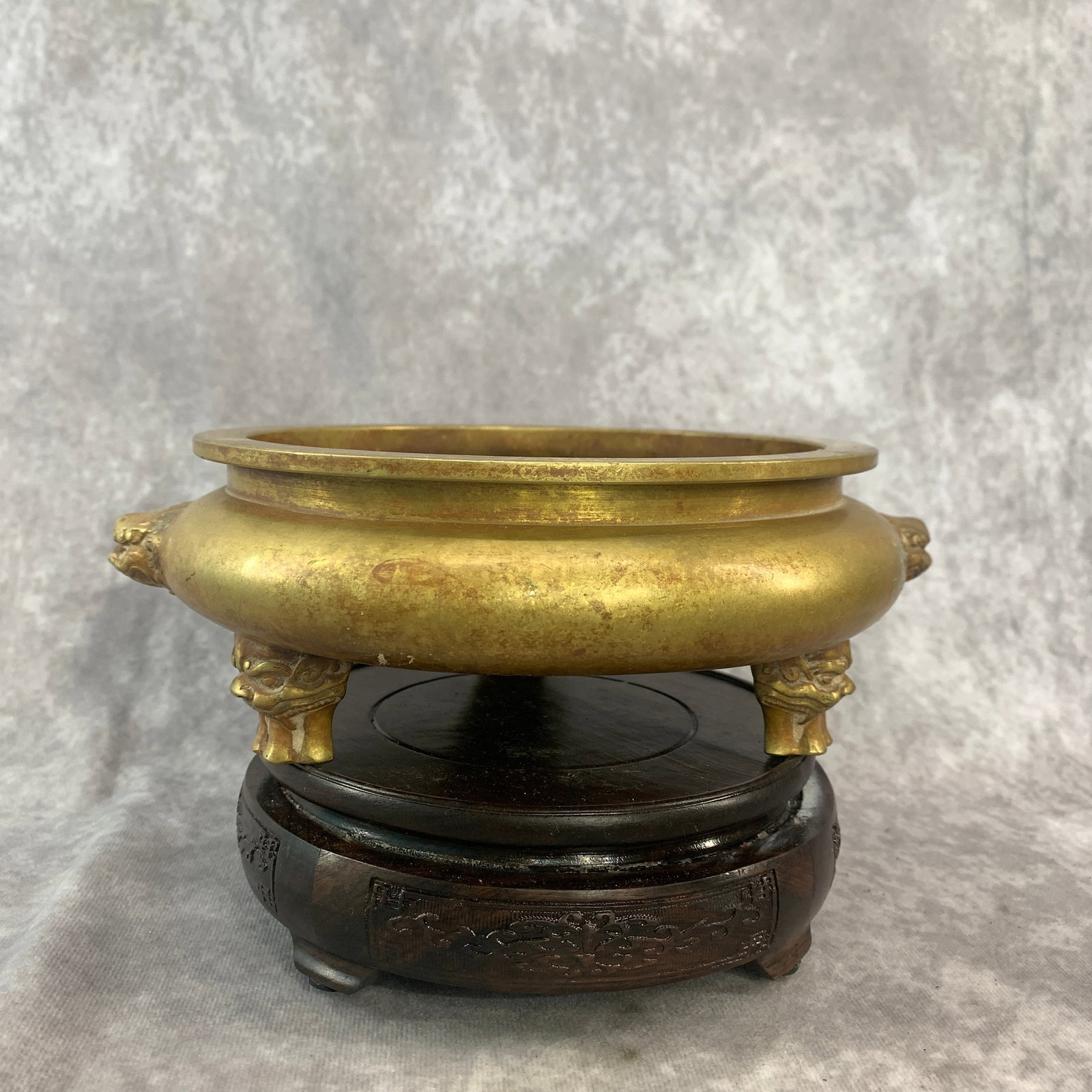 A LARGE BRONZE LION-MASK CENSER: Qing Dynasty; Long: 9.1 inch; High: 3 inch; Diameter: 7.8 inch; ;Wooden base for picture and display only.