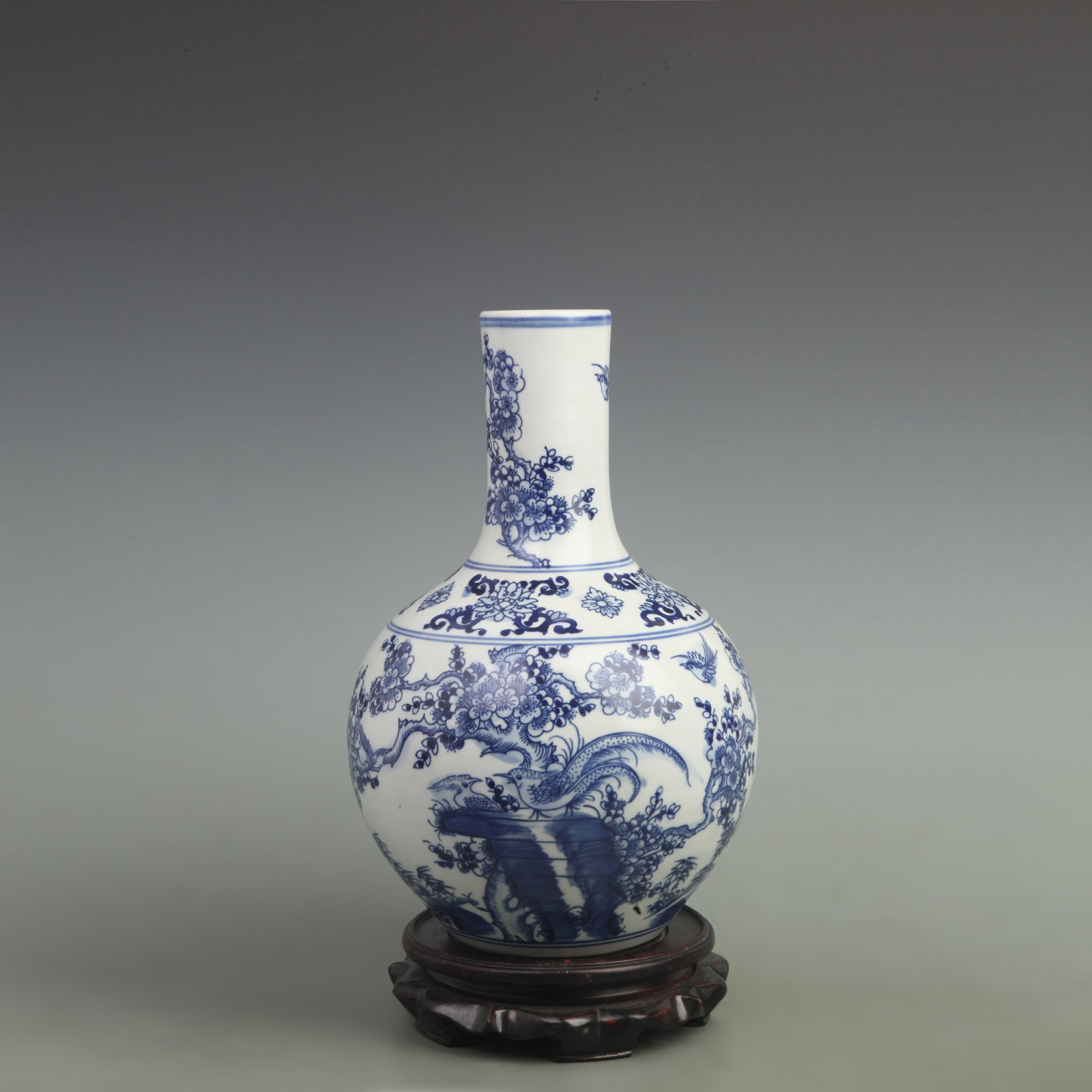 BLUE AND WHITE FLOWER AND BIRD PATTERN PORCELAIN BOTTLE: Qing Dynasty Kangxi Period; High: 13 inch; Width: 7.5 inch; ;Wooden base for picture and display only.