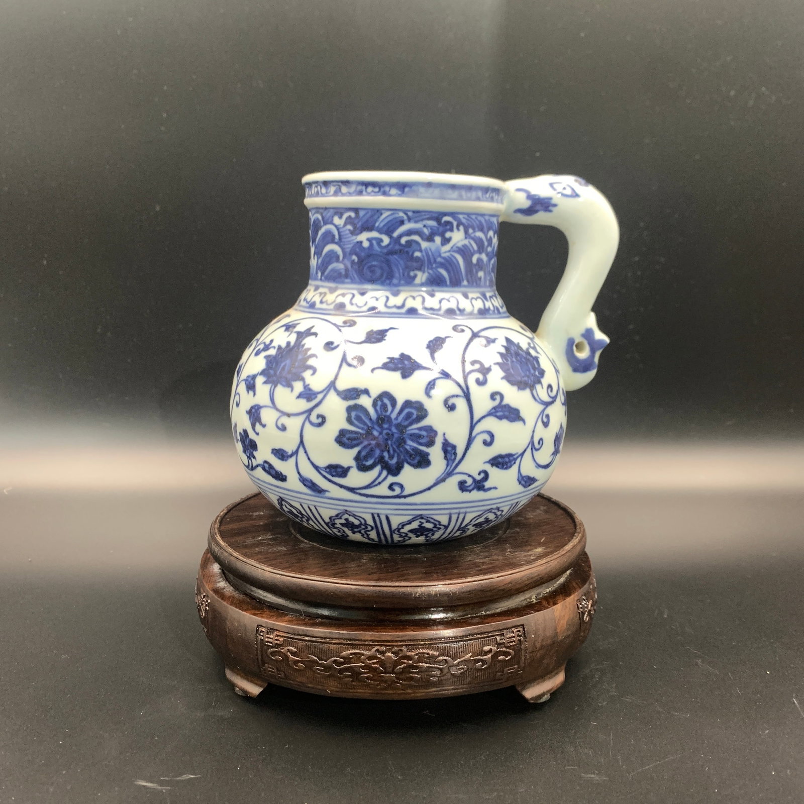 BLUE AND WHITE DRAGON-HANDLED PORCELAIN PITCHER: Qing Dynasty; High: 5.5 inch; Diameter: 5.4 inch; ;Wooden base for picture and display only.