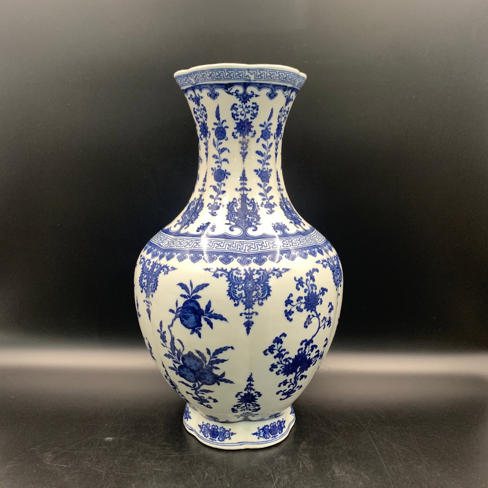 BLUE AND WHITE ROCOCO-STYLE LOBED PORCELAIN VASE: Qing Dynasty; High: 14.9 inch; Diameter: 8.9 inch; ;Wooden base for picture and display only.