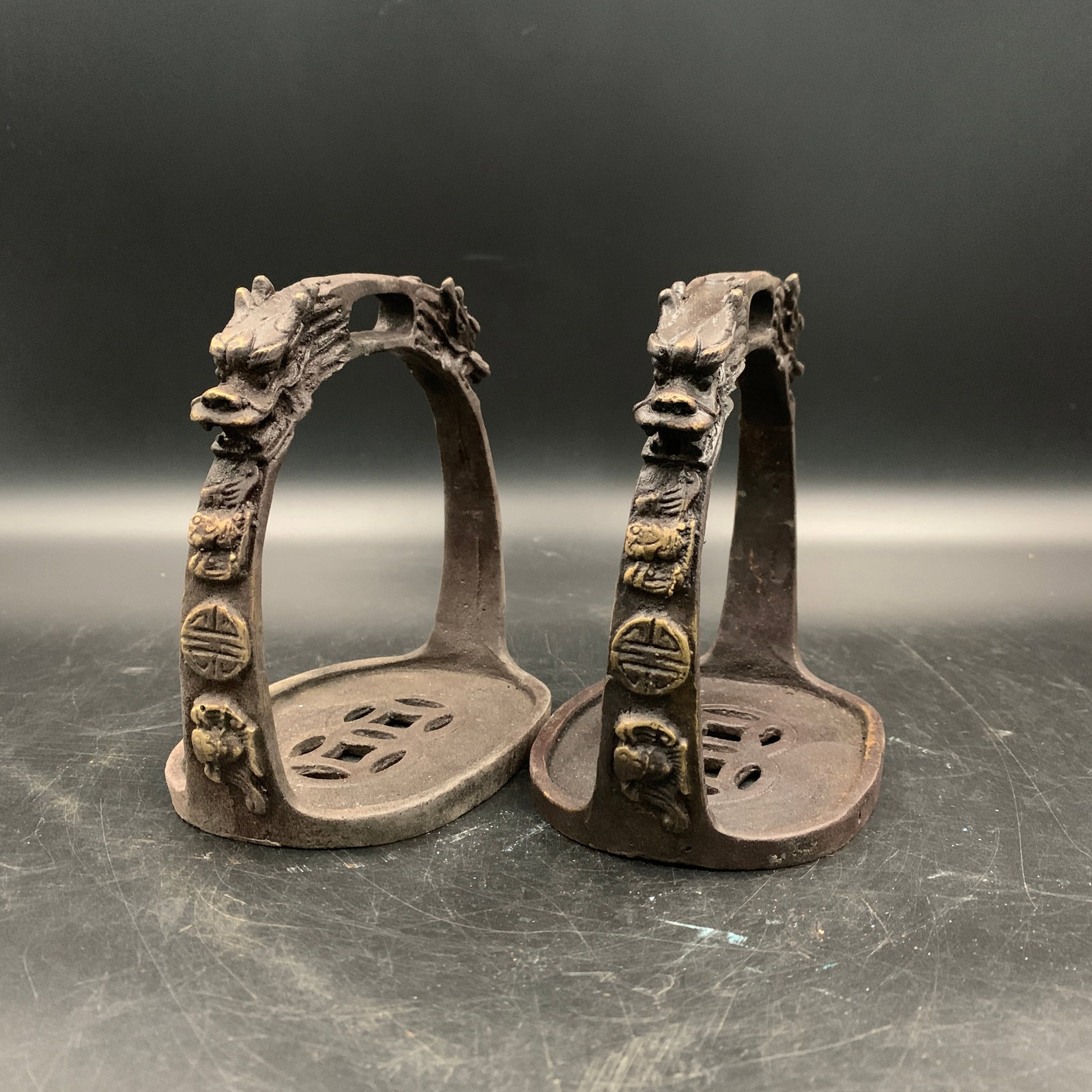 PAIR OF CHINESE BRONZE DRAGON-HEAD STIRRUPS: Republic Period; Long: 5.4 inch; Width: 3.6 inch; High: 5.3 inch; ;Wooden base for picture and display only.