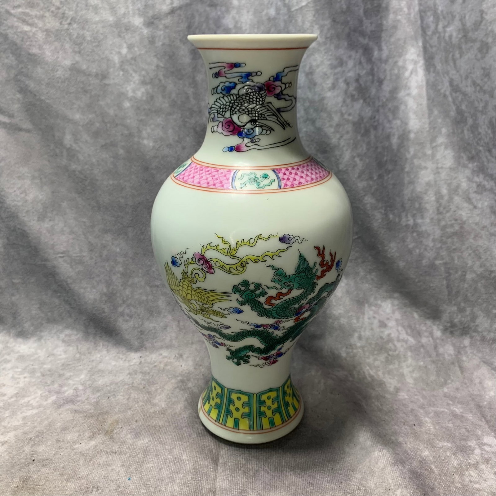 A QIANLONG-MARK FAMILLE ROSE DRAGON AND PHOENIX FIGURAL PLATE: Qing Dynasty; H; 9.9 inch; D; 4.8 inch;;Wooden base for picture and display only.