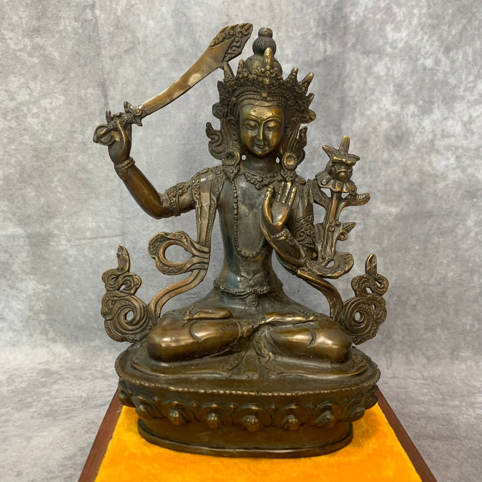 A FINE BRONZE MANJUSHREE STATUE: Qing Dynasty; High: 8.0 inch; Width: 6.2 inch; Long: 3.5 inch ;Wooden base for picture and display only.