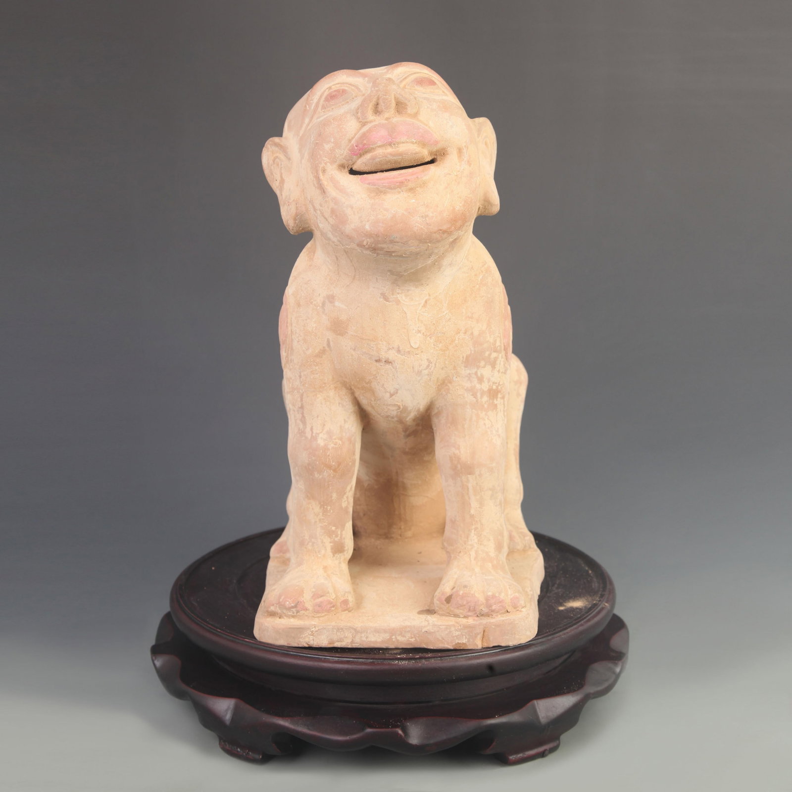A HANG DYNASTY STYLE HUMAN-FACED GRAVE-GUARDING BEAST: Han Dynasty Style; High: 12.0 inch; Width: 5.00 inch; Long: 9.00 inch; ;Wooden base for picture and display only.