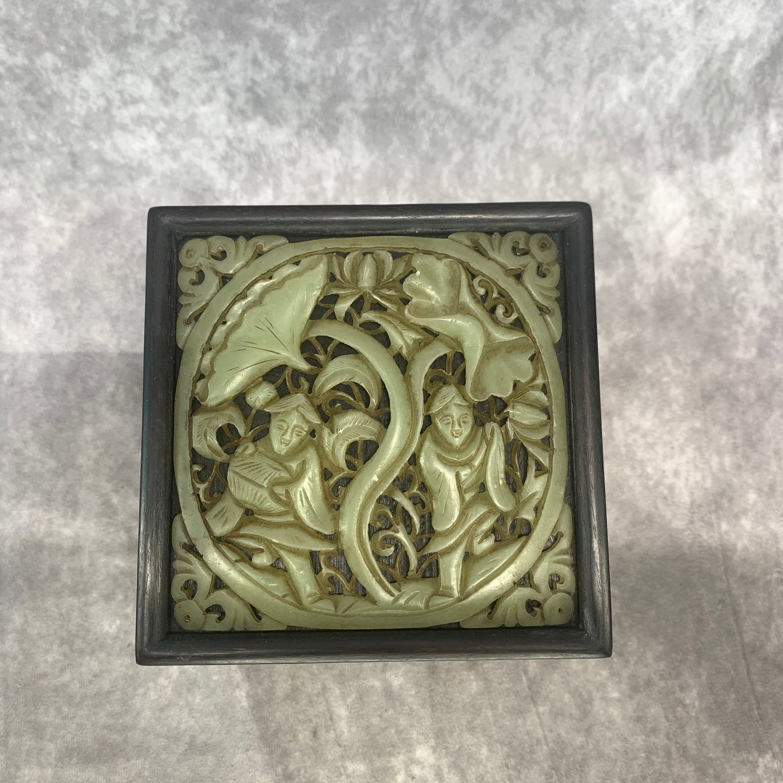 A FINE CARVED CELADON JADE BOX LID: Qing Dynasty; Long: 5.6 inch; Width: 5.6 inch; High: 3 inch; ;Wooden base for picture and display only.