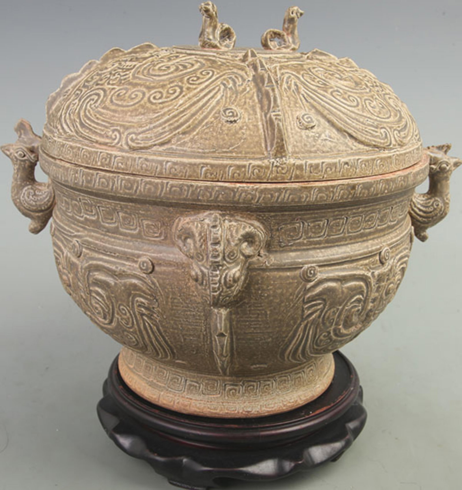 CELADON BEAST EAR LIDDED JAR: Jin Dynasty Style; High: 10 inch; Diameter: 10 inch; ;Wooden base for picture and display only.