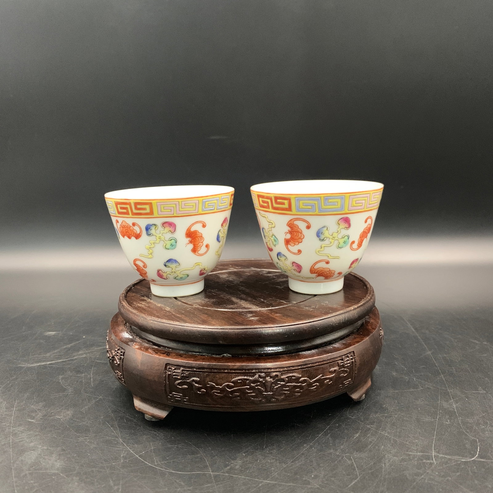 PAIR OF FAMILLE ROSE "FIVE BATS" (WUFU) TEACUPS: Republic Period; High: 2.5 inch; Diameter: 3 inch; ;Wooden base for picture and display only.