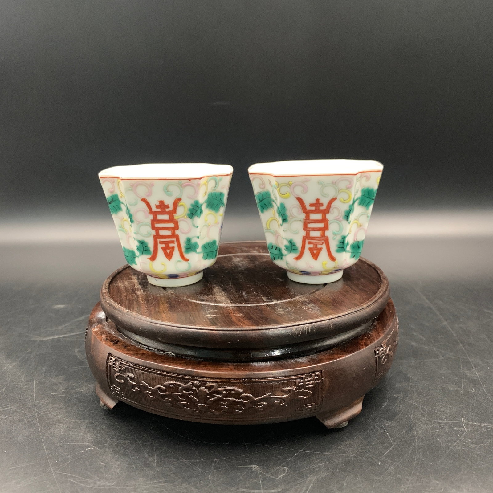 PAIR OF FAMILLE ROSE "WANSHOU WUJIANG" WINE CUPS: Republic Period; Long: 2.6 inch; Width: 2.6 inch; High: 2.3 inch; ;Wooden base for picture and display only.