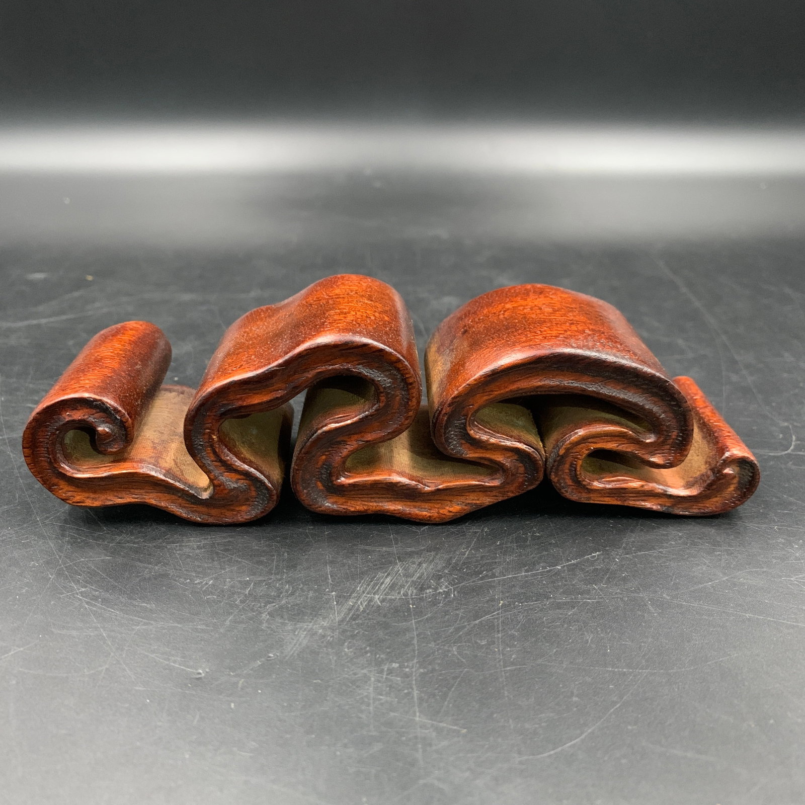 CARVED ZITAN WOOD RUYI-SCROLL BRUSH REST: Republic Period; Long: 6.6 inch; Width: 1.8 inch; High: 1.6 inch; ;Wooden base for picture and display only.
