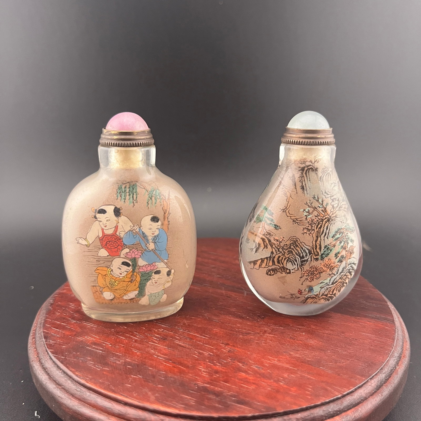 PAIR OF INSIDE-PAINTED SNUFF BOTTLES: Modern; Long: 1.78 inch; Width: 1.1 inch; High: 2.7 inch; Long: 1.68 inch; Width: 1.02 inch; High: 2.7 inch; ;Wooden base for picture and display only.