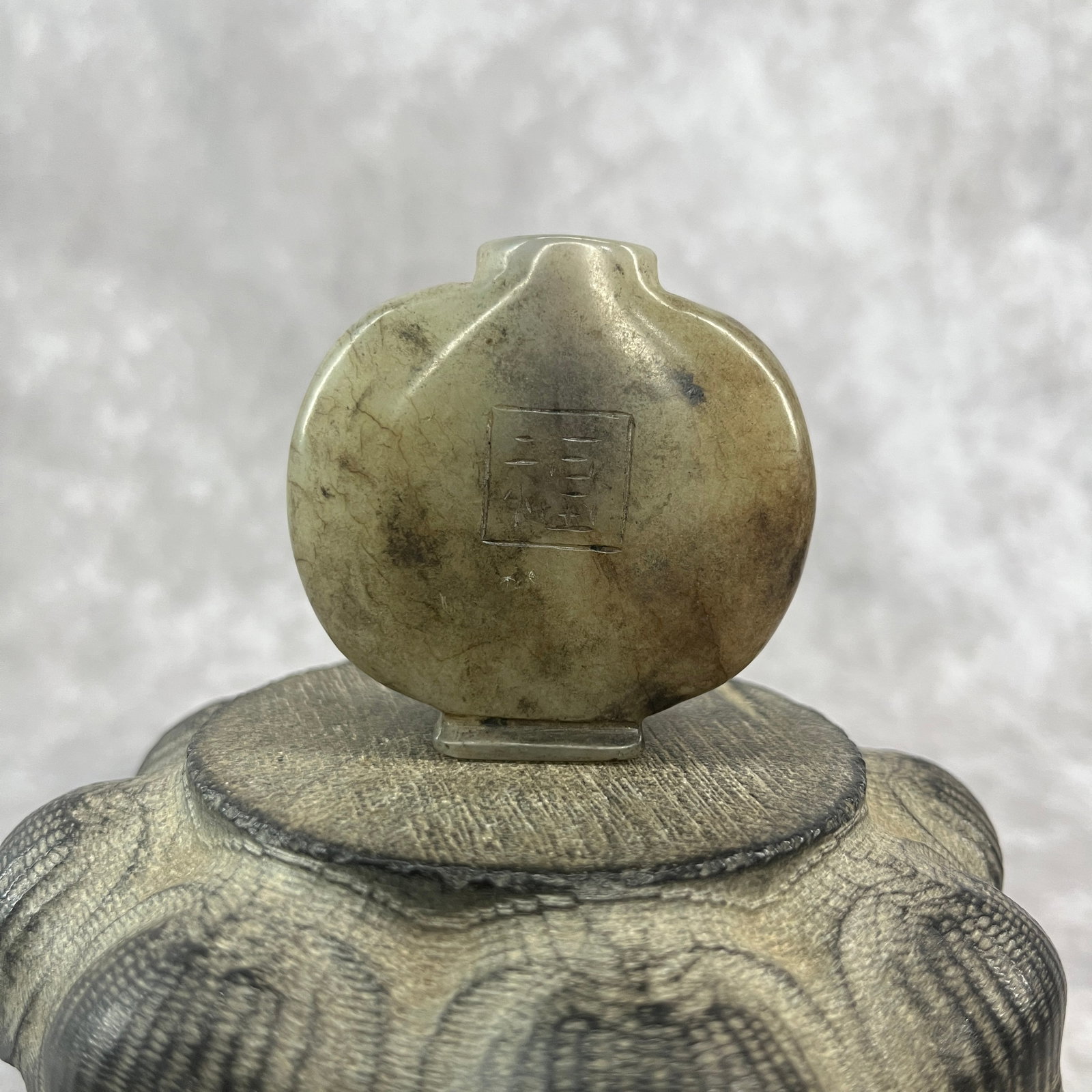 A FINE HETIAN JADE MADE SNUFF BOTTLE: Qing Dynasty; Long: 2.2 inch; Width: 2.08 inch; High: 0.72 inch; ;Wooden base for picture and display only.