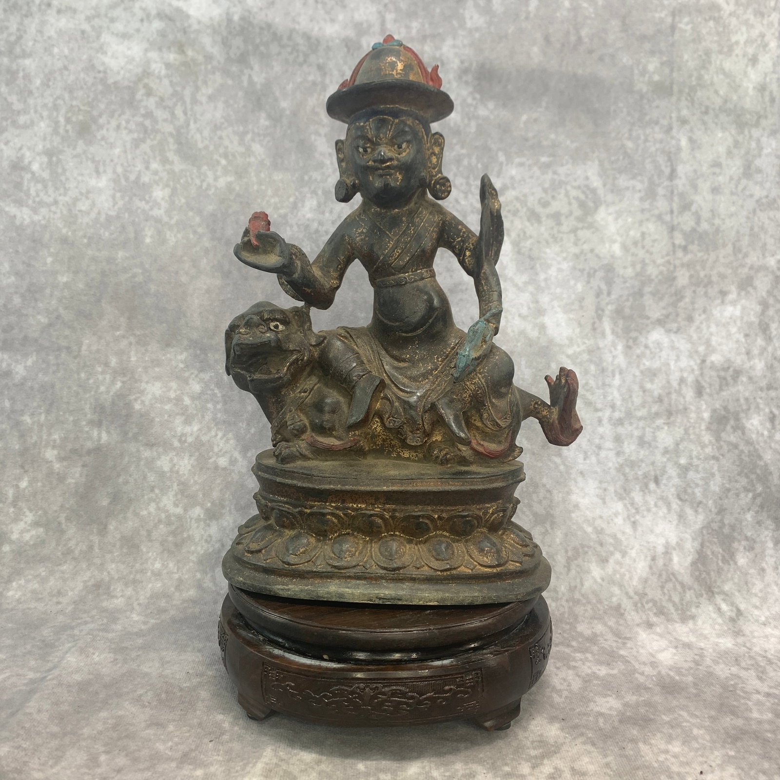 A FINE BRONZE DAMCHEN GARWA NAGPO (THE BLACK SMITH): Qing Dynasty; Long: 6.4 inch; Width: 4 inch; High: 10.6 inch; ;Wooden base for picture and display only.