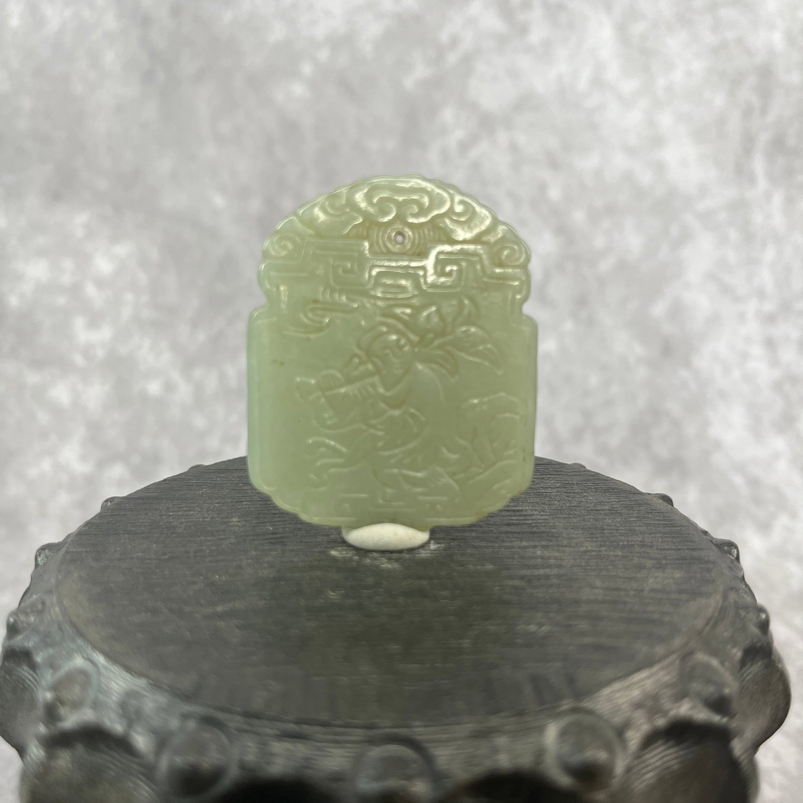 A FINE HETIAN JADE PENDANT IN FIGURE OF PLAYING BOY: Qing Dynasty; Long: 2 inch; Width: 1.6 inch; High: 0.18 inch; ;Wooden base for picture and display only.