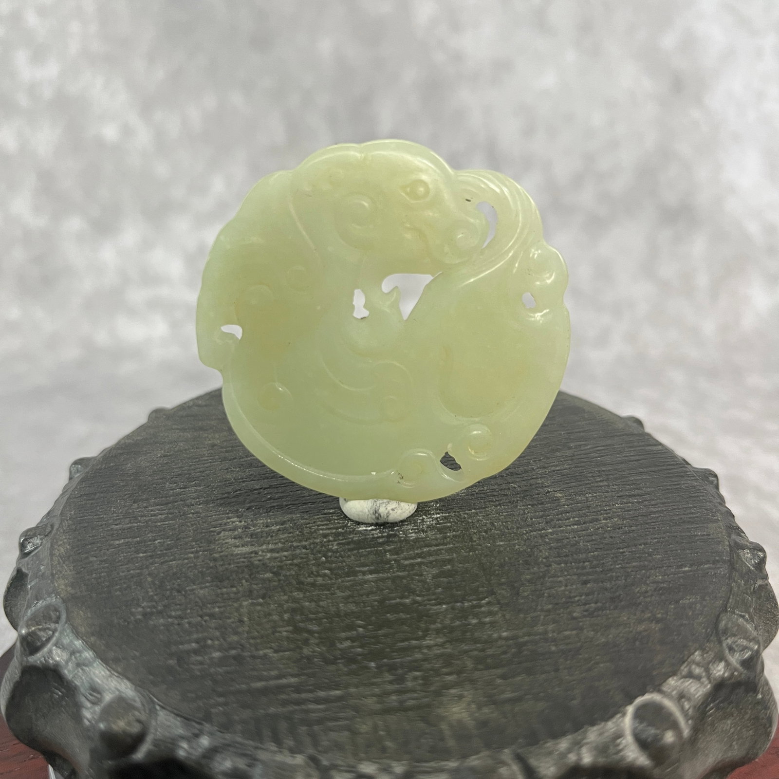 HETIAN JADE COILED DRAGON PENDANT: Republic Period; High: 0.19 inch; Diameter: 1.95 inch; ;Wooden base for picture and display only.