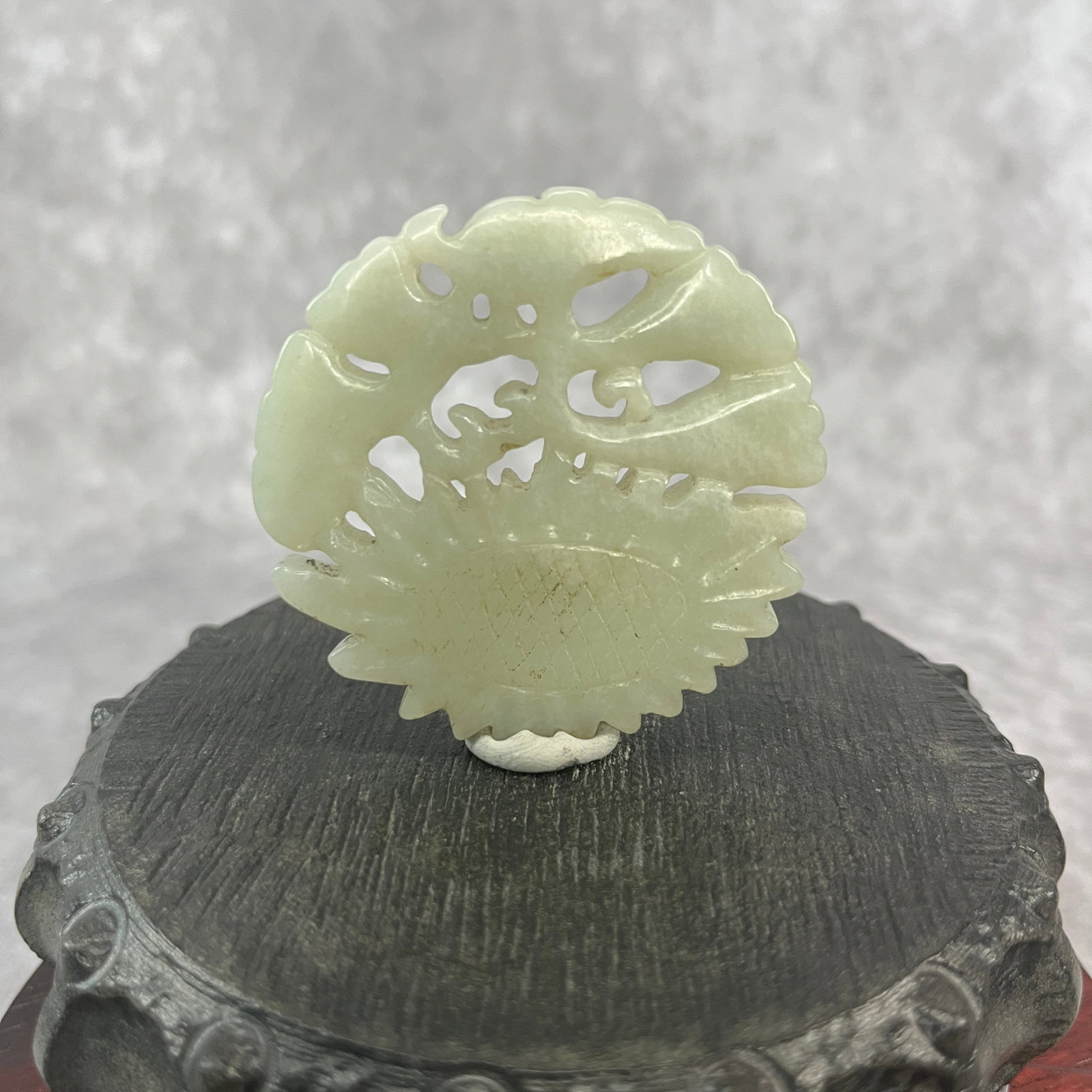 HETIAN JADE SUNFLOWERS AND FOLIAGE PLAQUE: Republic Period; High: 0.23 inch; Diameter: 2.2 inch; ;Wooden base for picture and display only.