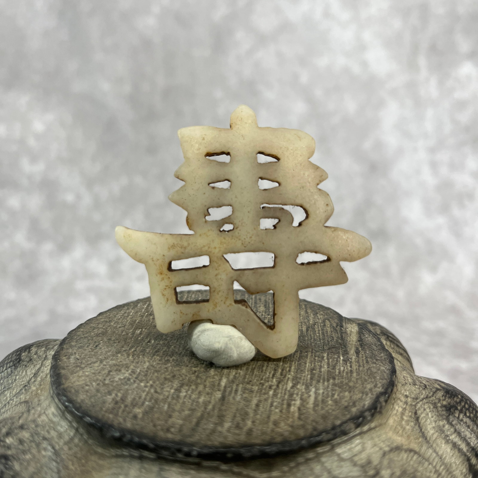 A FINE HETIAN JADE "SHOU" CHARACTER PENDANT: Republic Period; Long: 2.08 inch; Width: 2.1 inch; High: 0.22 inch; ;Wooden base for picture and display only.