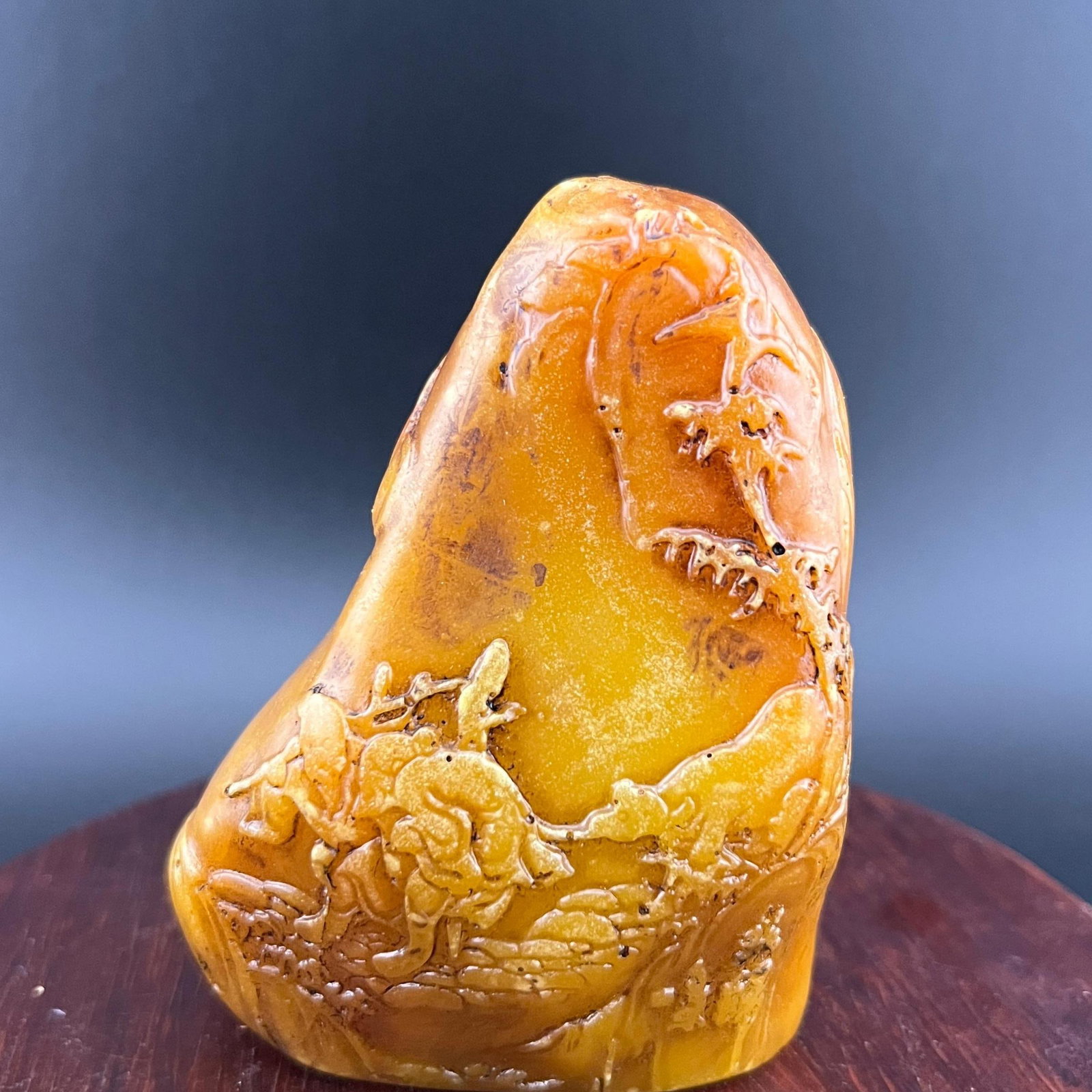 A FINE TIAN HUANG STONE CARVING, CLIFF EXCURSION: Modern; Long: 2.3 inch; Width: 1.2 inch; High: 2.9 inch; ;Wooden base for picture and display only.