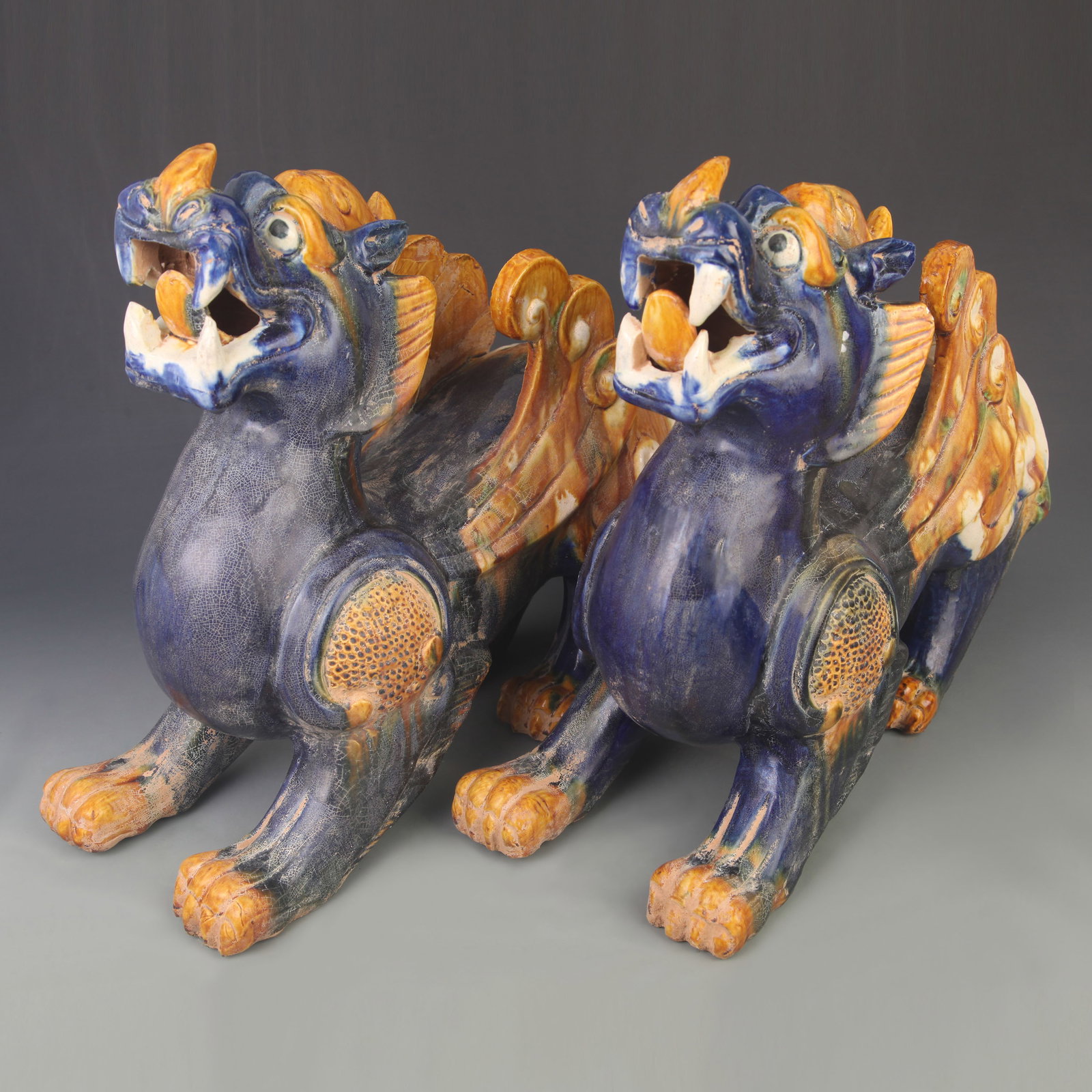 PAIR OF TRI COLORED MYTHICAL BEAST POTTERY FIGURE: Tang Dynasty Style; High: 14.5 inch; Width: 4.50 inch; Long: 18.5 inch; ;Wooden base for picture and display only.